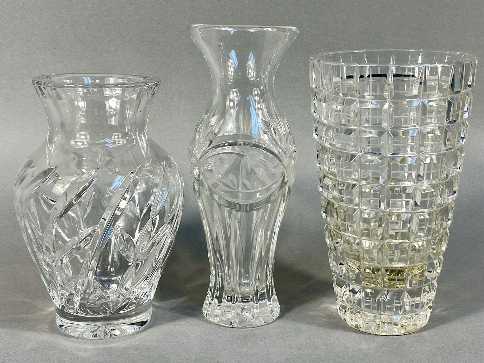 A Trio of Cut Crystal Bud Vases Including Gorham Victoria's Garden: A collection of three clear cut crystal or heavy pressed glass bud vases. The lot includes one vase identified through research as the Gorham Victoria's Garden pattern, often noted as being made in Po