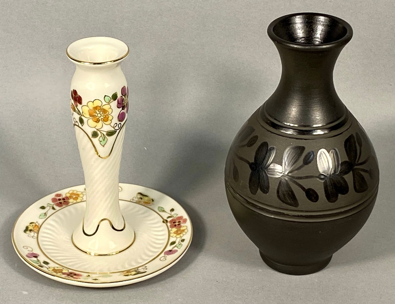 Two Hungarian Vases Including Zsolnay Porcelain and Kovats Hajos Stoneware: A collection of two Hungarian ceramic items. The first item is a white glazed porcelain bud vase or candlestick on a circular base, produced by Zsolnay. The piece features a central, tapered column ri