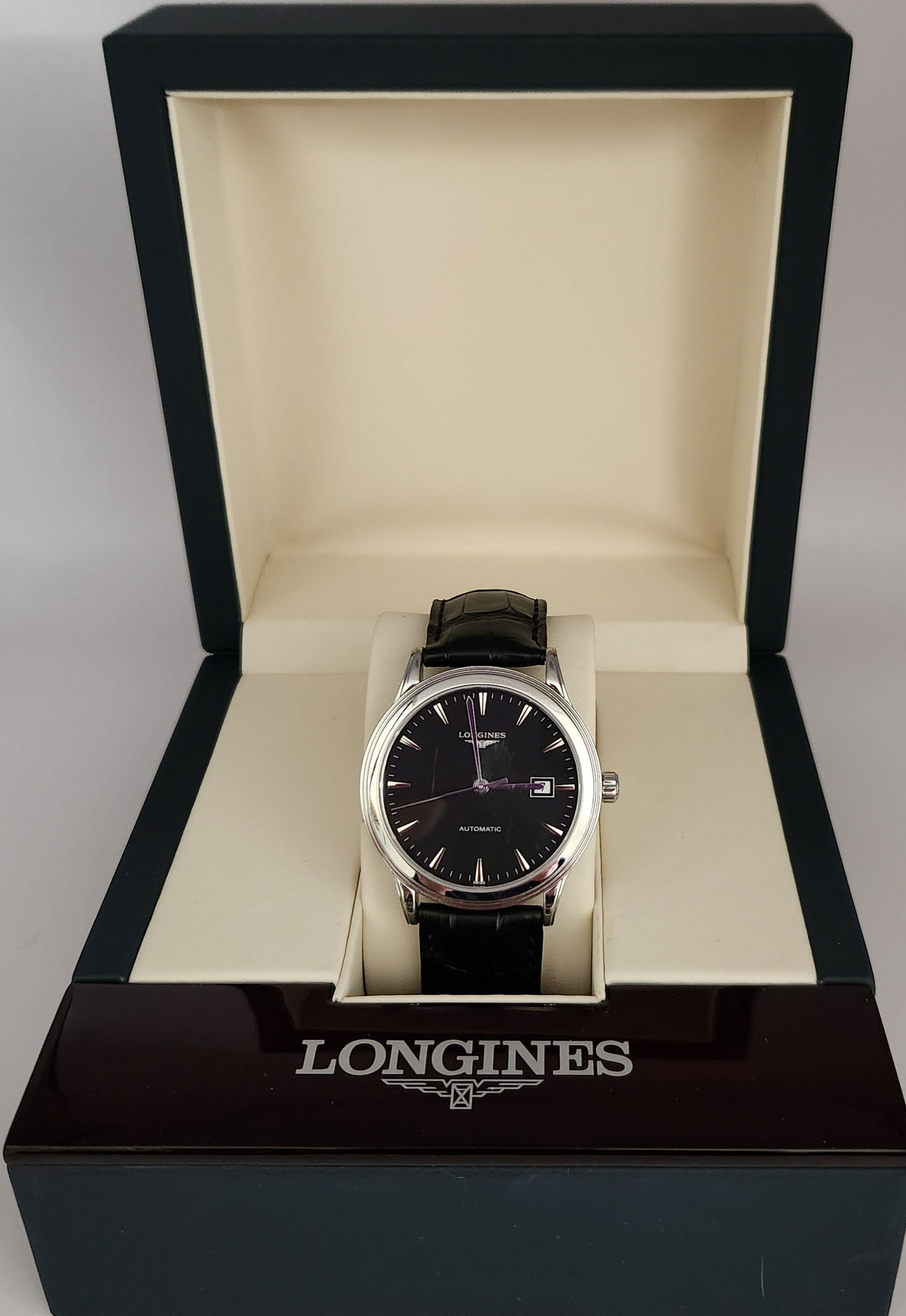 Longines Flagship Stainless Steel Automatic Watch Ref. L4.984.4: A Longines Flagship automatic wristwatch featuring a polished stainless steel case and an exhibition case back. The black dial is designed with silver-tone baton hour markers, matching hands, and a da