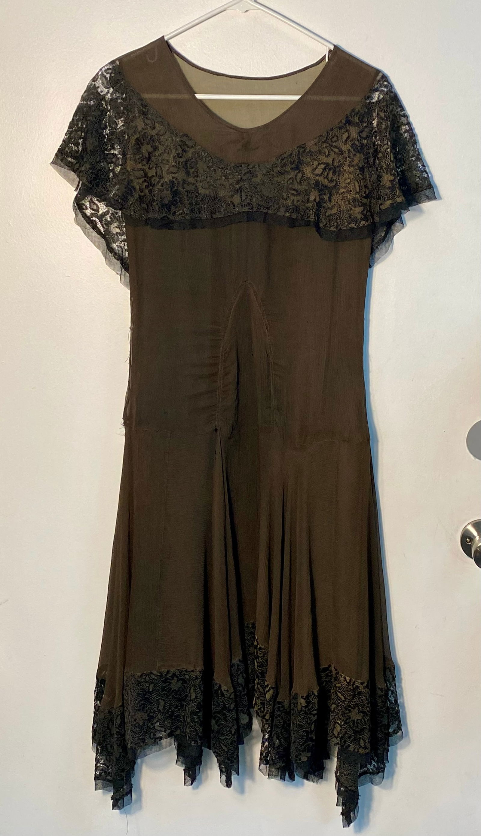 An Art Deco Brown Silk Chiffon and Lace Evening Dress: This evening dress dates from the late 1920s to early 1930s and features a drop-waist silhouette characteristic of the Art Deco period. The garment is constructed from a sheer chocolate-brown silk chi