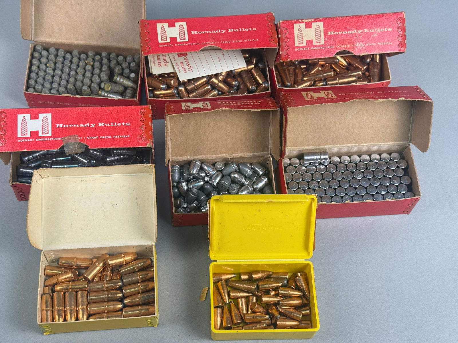 A Collection of Vintage Reloading Bullet Components by Hornady, Speer, Sierra, and Remington: A collection of vintage reloading bullet component boxes and projectiles from manufacturers including Hornady Manufacturing Company, Speer Bullets, Sierra Bullets, and Remington. The assortment