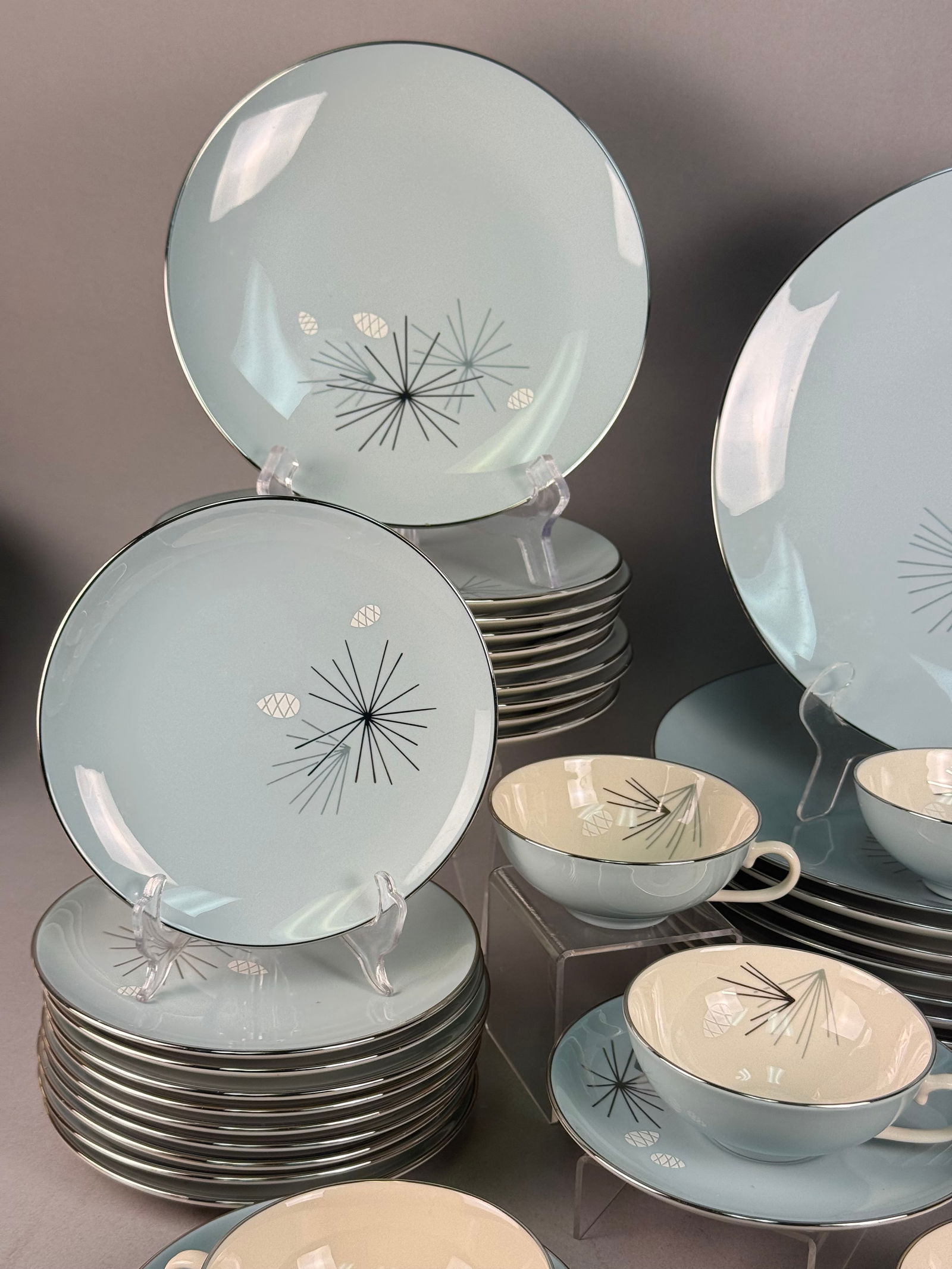 A Collection of Franciscan Masterpiece China Silver Pine Dinnerware: A collection of Franciscan Masterpiece China fine china dinnerware in the Silver Pine pattern, manufactured by Gladding, McBean and Co. in the USA. The set features a light blue exterior ground with c