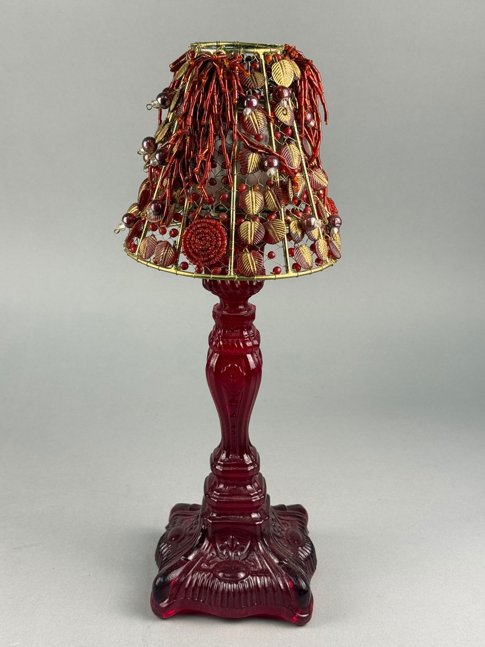 A Ruby Red Pressed Glass Candlestick with Beaded Wirework Shade (1 of 8)