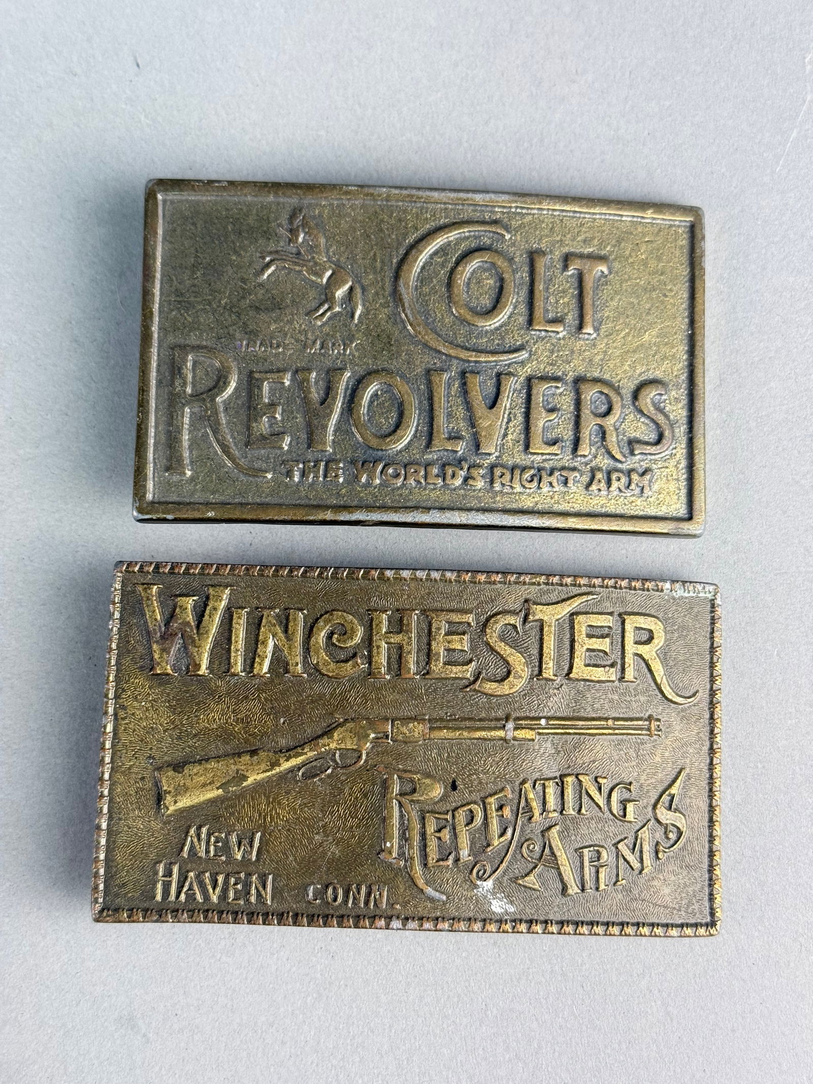 A Pair of Winchester Repeating Arms and Colt Revolvers Advertising Belt Buckles (1 of 8)