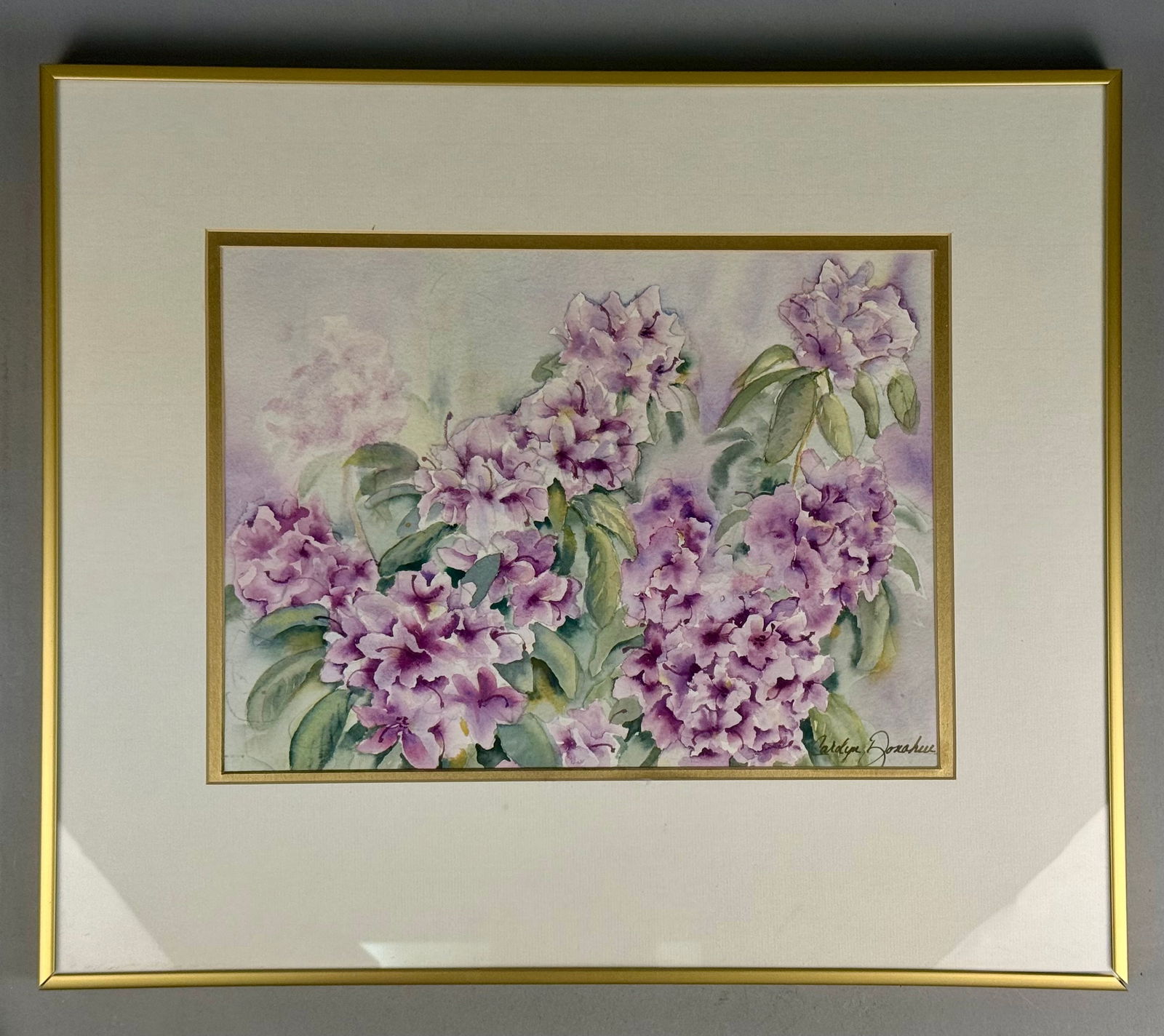 Carolyn Donahue, Purple Rhododendron Watercolor Painting: This original watercolor painting on paper depicts a cluster of purple and lavender rhododendron blossoms set against green foliage. The work is executed in an impressionistic style and is signed Caro