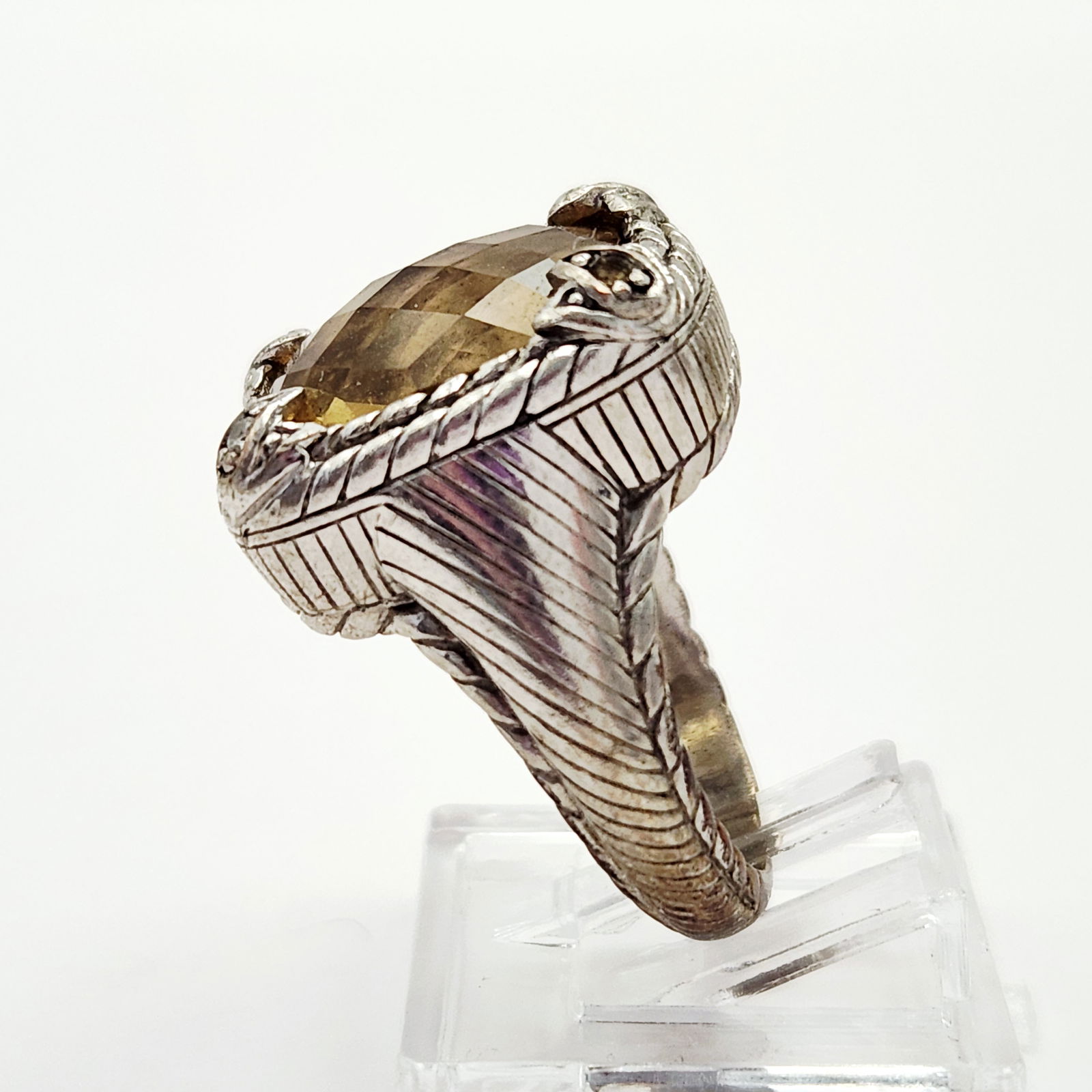 Judith Ripka Sterling Citrine Ring 11.9 Grams: A Judith Ripka designer ring featuring a large, cushion-cut, faceted yellow citrine stone set within a sterling silver frame. The mounting and band exhibit the designer signature textured rope and lin