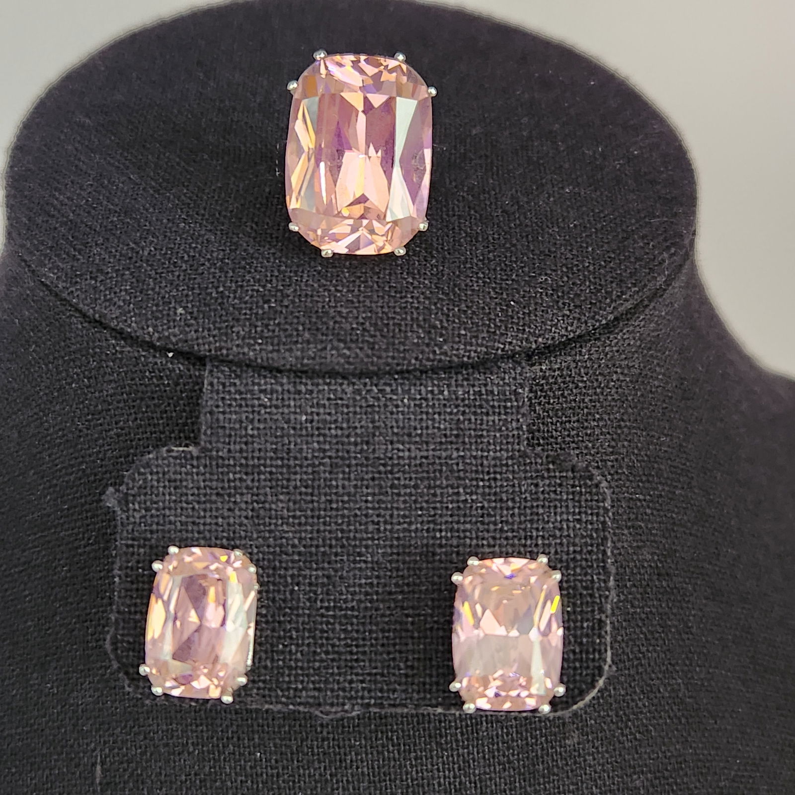 Ipanema Sterling Pink Gemstone Set 18.3 Grams: A jewelry suite by Ipanema comprising a ring and a pair of stud earrings. Each item is set with a large, cushion-cut pale pink gemstone. The gemstones are secured within sterling silver multi-prong ba
