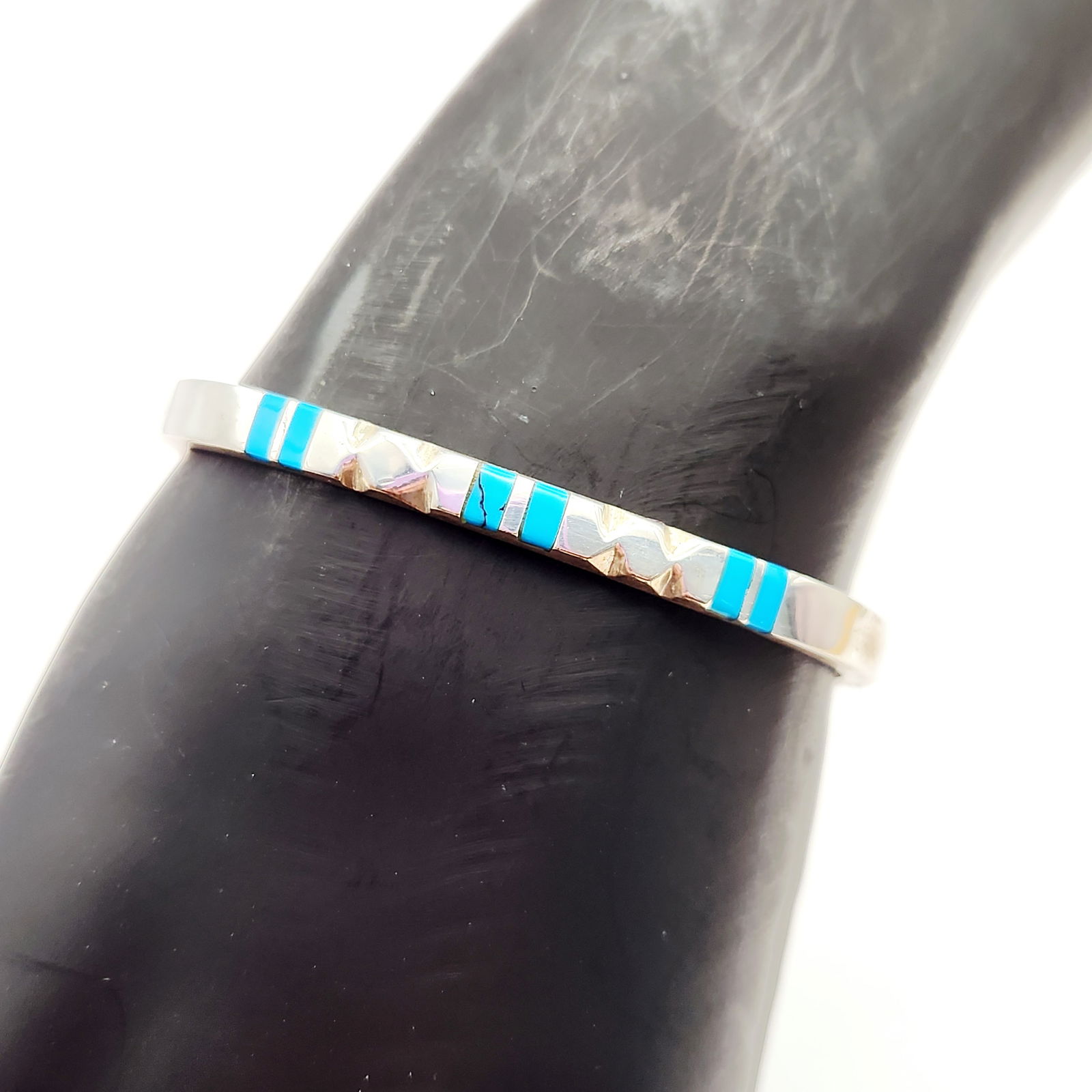 Sterling Inlaid Turquoise Bracelet 18.9 Grams: This Mexican sterling silver hinged bangle bracelet features channel-set geometric inlays of turquoise. The interior of the band is stamped with 925 MEXICO TV-157, identifying the material as sterling