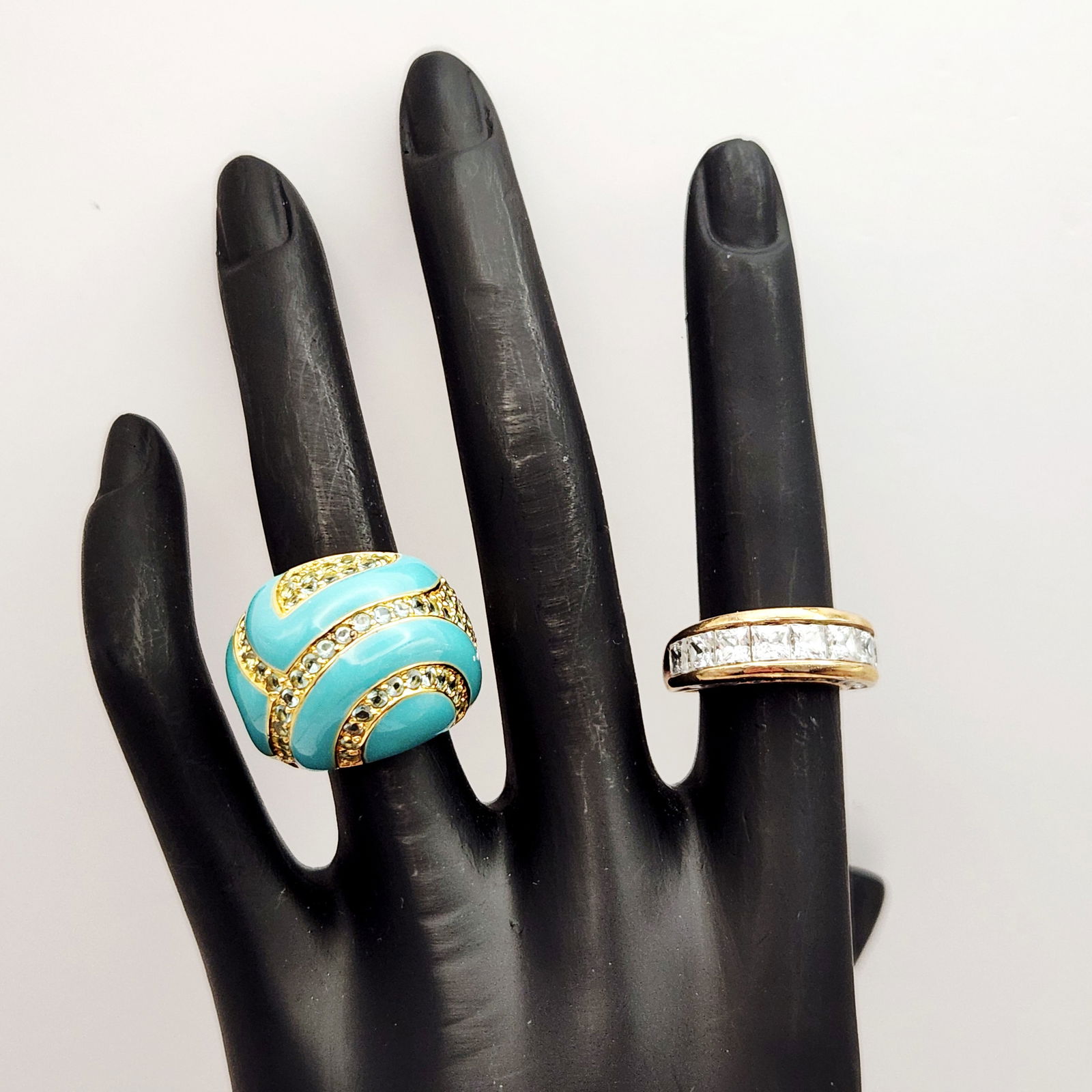 Vermeil Fashion Rings 21.1 Grams: Two contemporary fashion rings constructed from gold over sterling (vermeil) silver. The first item is a wide domed statement ring featuring a turquoise-colored enamel swirl pattern accented by rows o