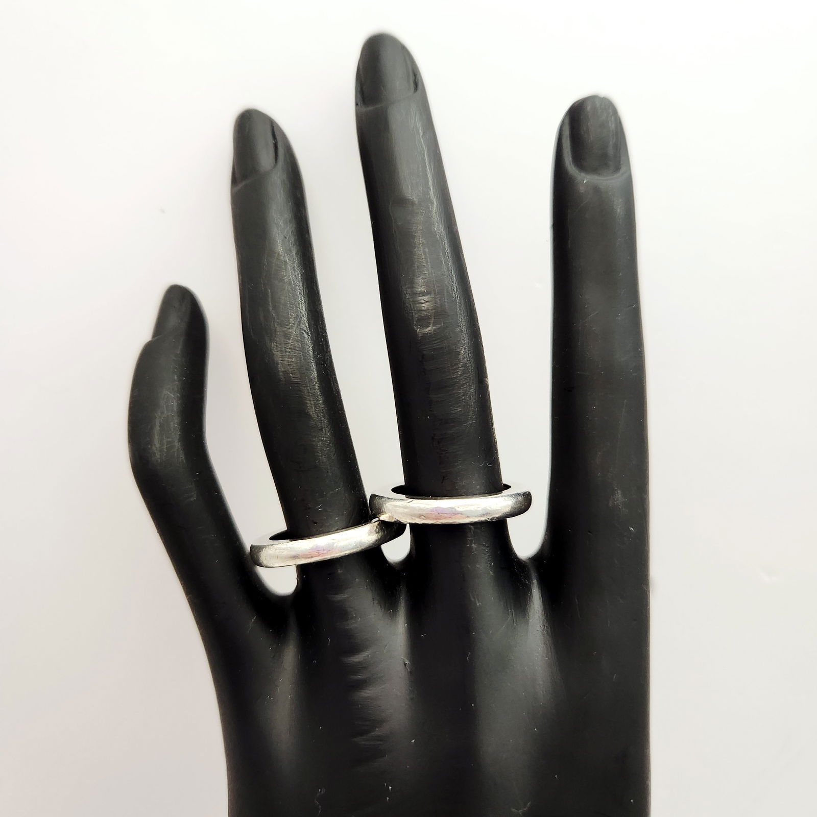 Pair Sterling Rings 12.2 Grams: A pair of interlocking silver-toned metal rings, designed as two simple, rounded bands permanently joined together. The rings feature a minimalist, contemporary style with no visible hallmarks or