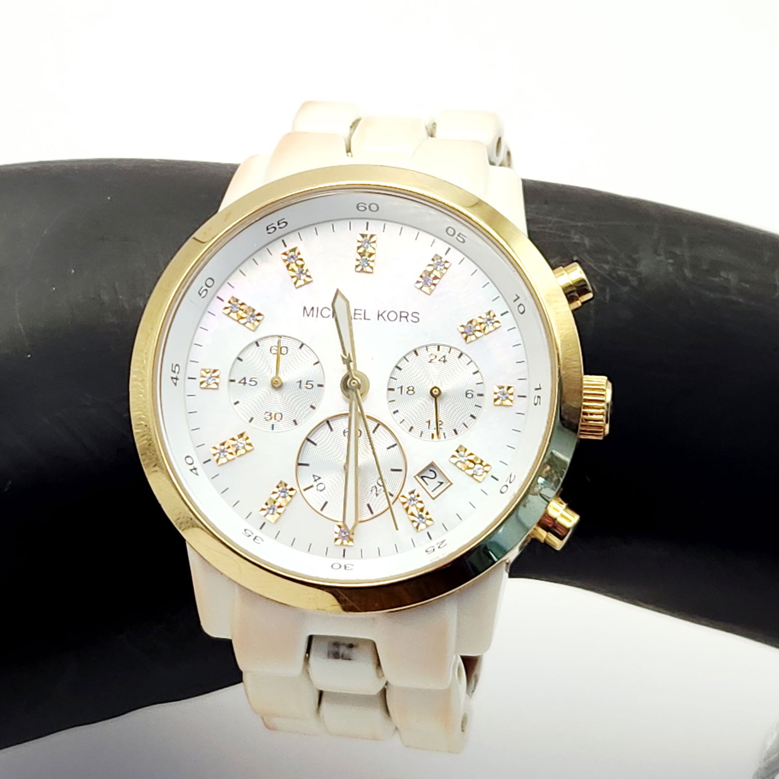 Michael Kors MK-5218 Gold-Tone Chronograph Wristwatch: A Michael Kors chronograph wristwatch, model MK-5218. The timepiece features a gold-tone stainless steel case housing a mother-of-pearl dial. The dial is detailed with crystal-set hour markers, three