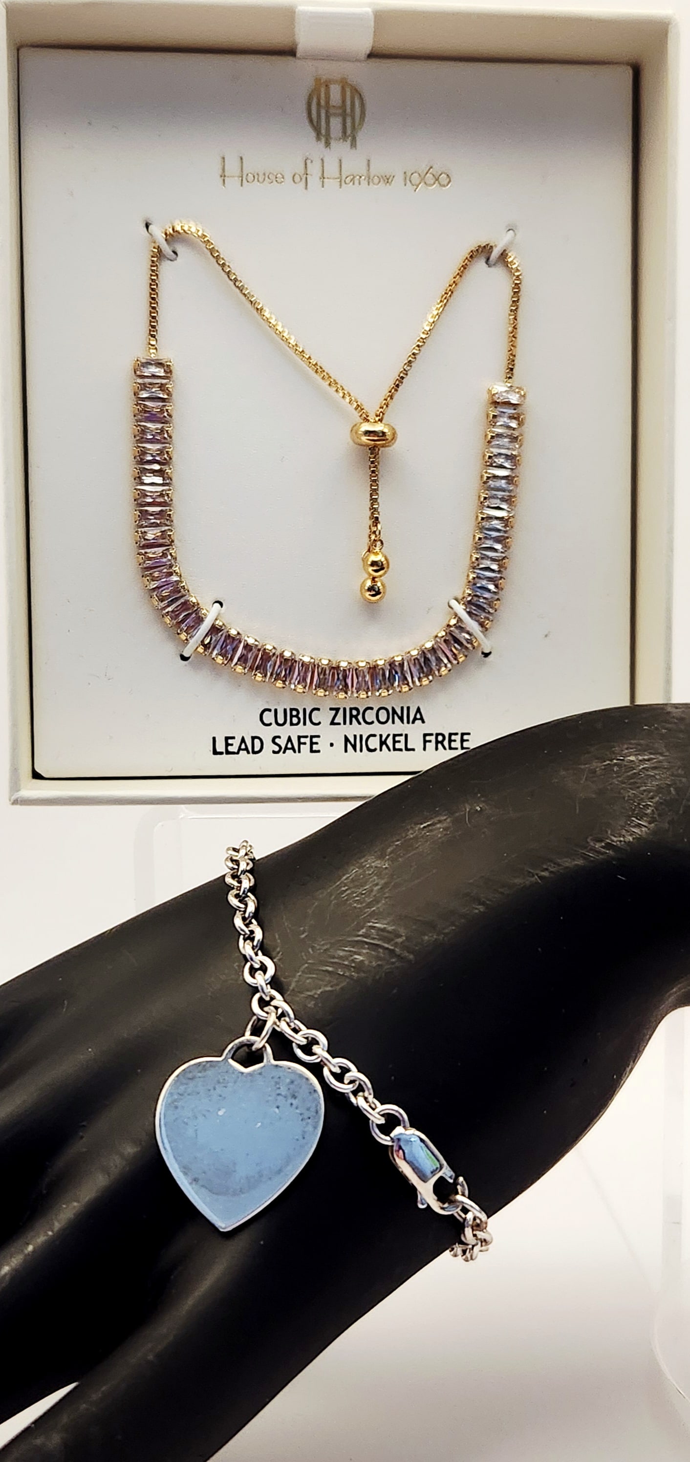925 Sterling Heart Bracelet (8.5 Grams) & Gold Tone CZ Bracelet: A jewelry collection featuring a House of Harlow 1960 adjustable bolo-style bracelet and a sterling silver heart charm bracelet. The House of Harlow piece is crafted in gold-tone metal featuring a row