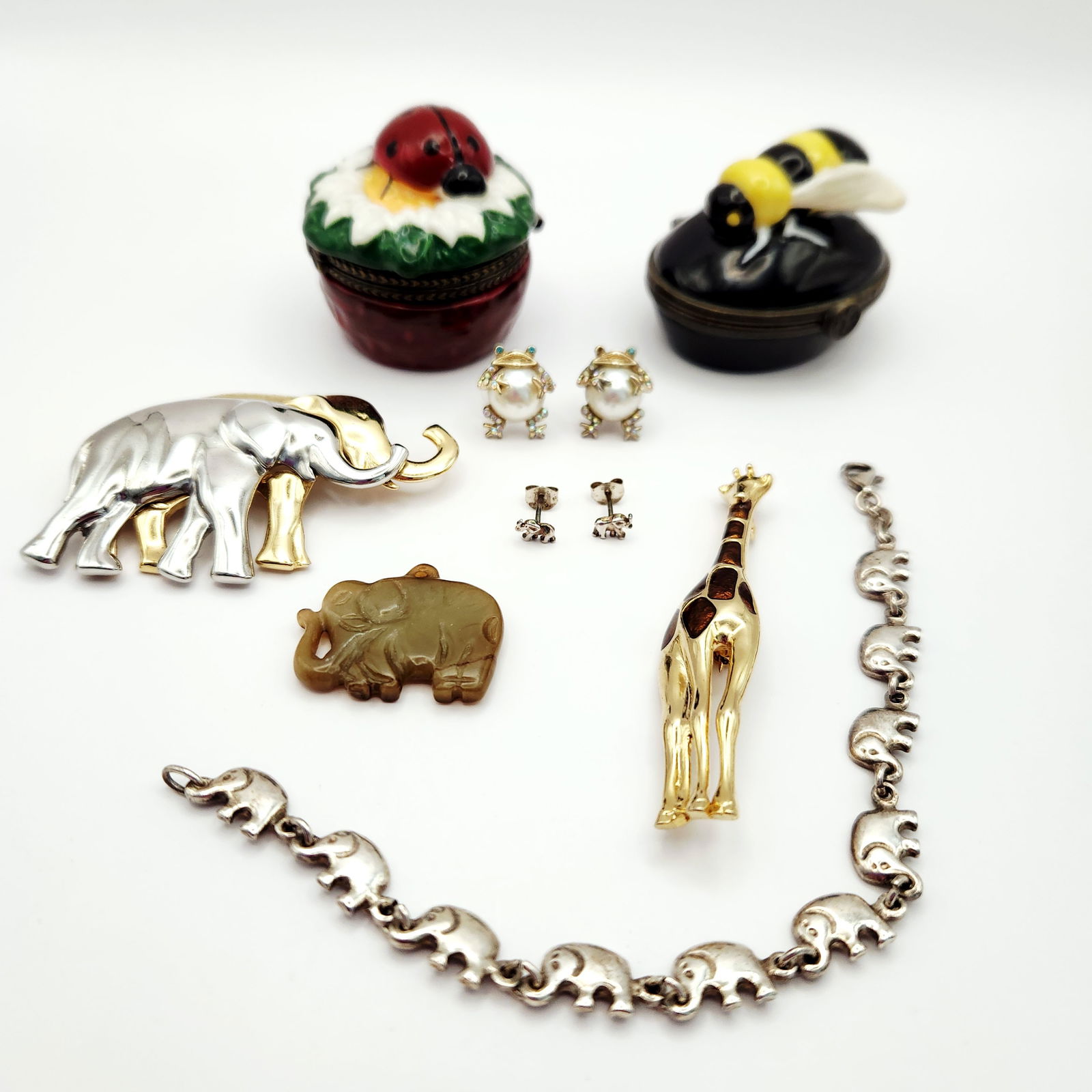 Animal-Themed Items Including Sterling 12.4 Grams: A collection of animal-themed jewelry and decorative objects featuring various species and materials. The group includes a sterling silver link bracelet composed of elephant-shaped links, marked 925 a
