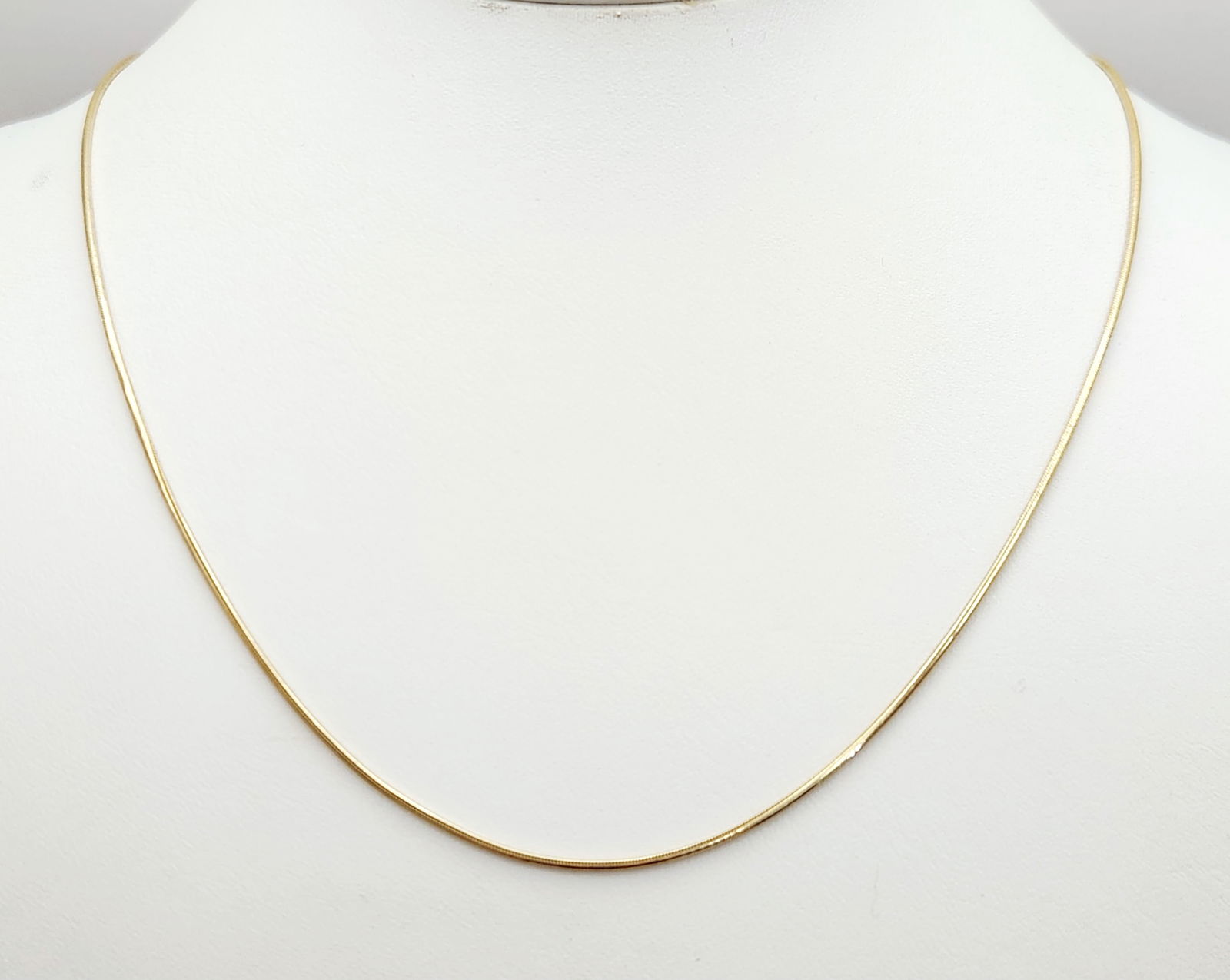 14K Gold Chain Necklace 6.9 Grams: A 14-karat yellow gold necklace featuring a snake chain construction. The piece consists of a fine, flexible chain with a polished finish, secured by a lobster claw clasp. Hallmarks including 585,