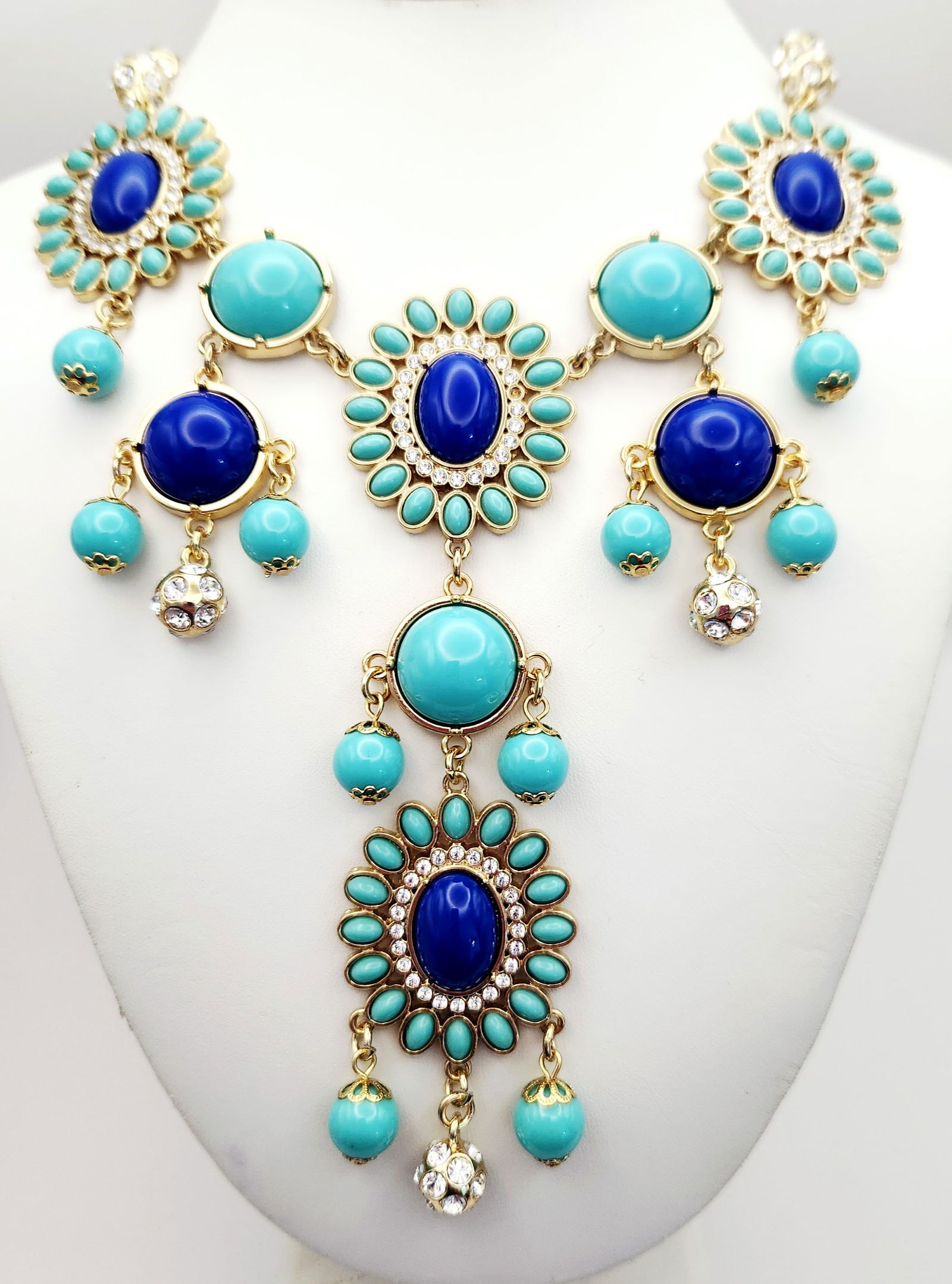 A Lilly Pulitzer Gold-Tone Bib Statement Necklace: A Lilly Pulitzer bib-style statement necklace featuring a gold-tone metal chain and a tiered centerpiece. The design is embellished with turquoise and royal blue cabochons, accented by pavé-set