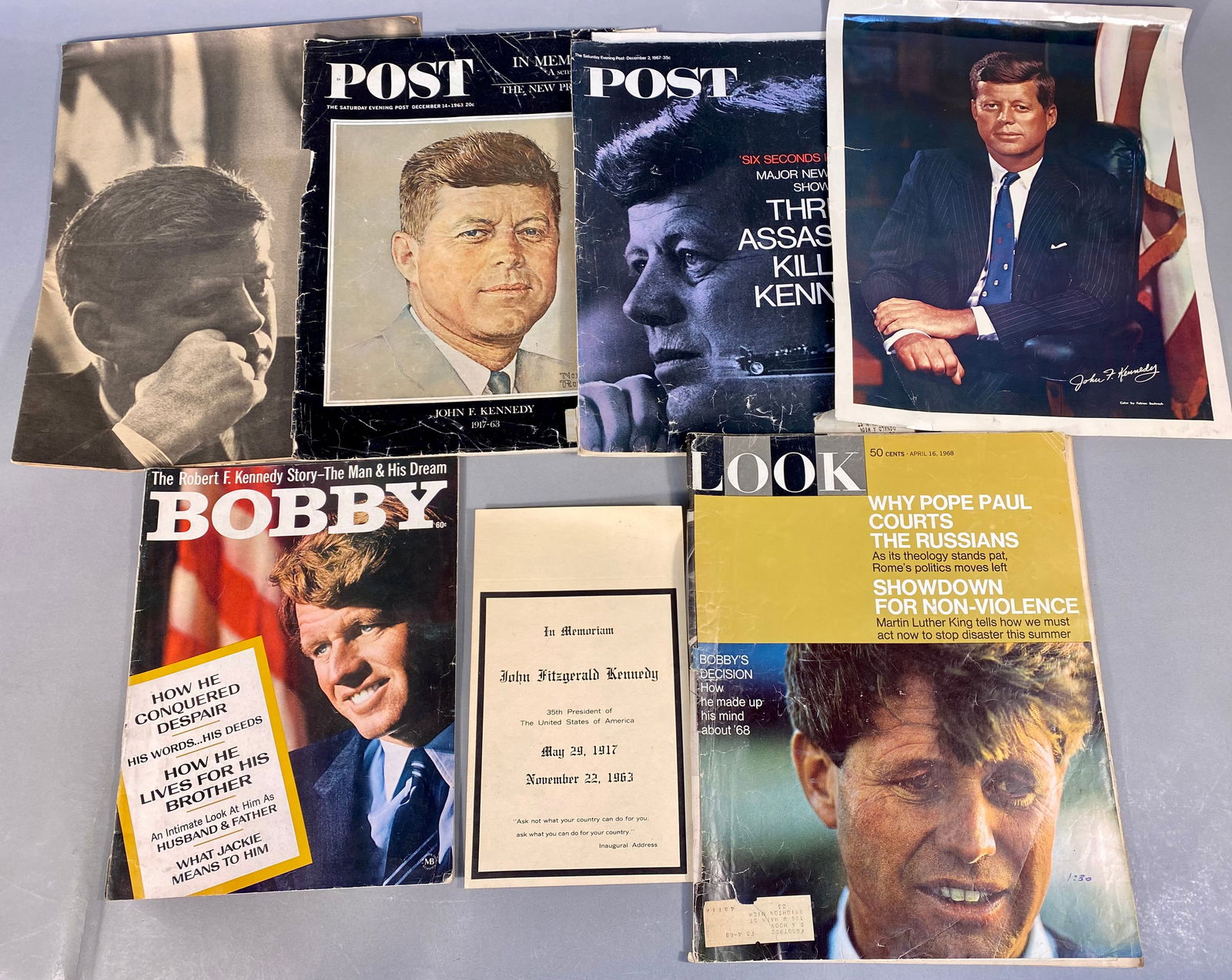 A Collection of Kennedy Family Ephemera including an In Memoriam Card for John Fitzgerald Kennedy: This collection features various vintage print media documenting the lives and legacies of John F. Kennedy and Robert F. Kennedy. The group includes an In Memoriam card for President John Fitzgerald K