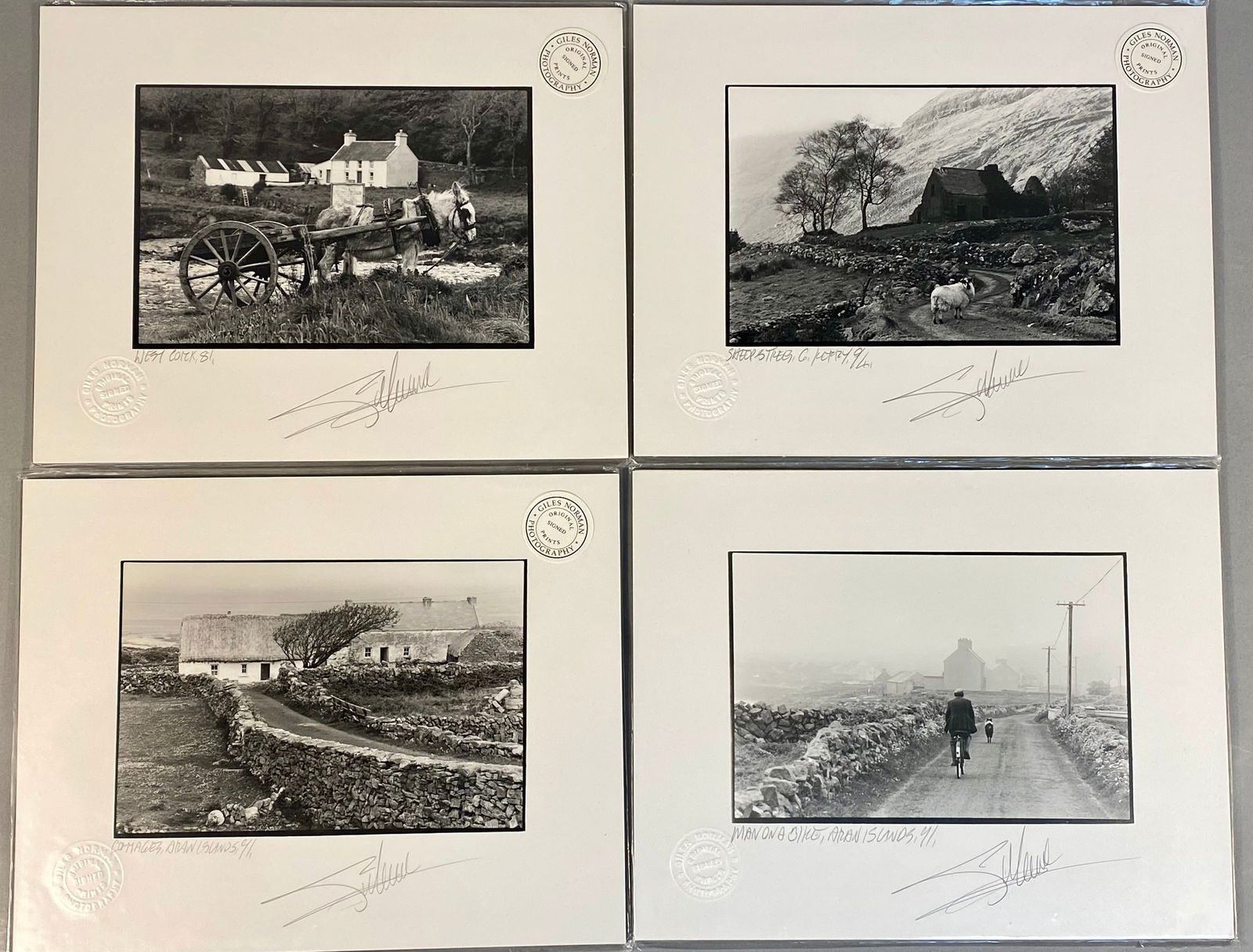 A Group of Giles Norman Original Signed Prints: A group of four black and white landscape photographs by artist Giles Norman, featuring rural Irish scenes. The collection includes works titled West Cork, 81, Sheep and Trees, Co. Kerry, 94, Cottages