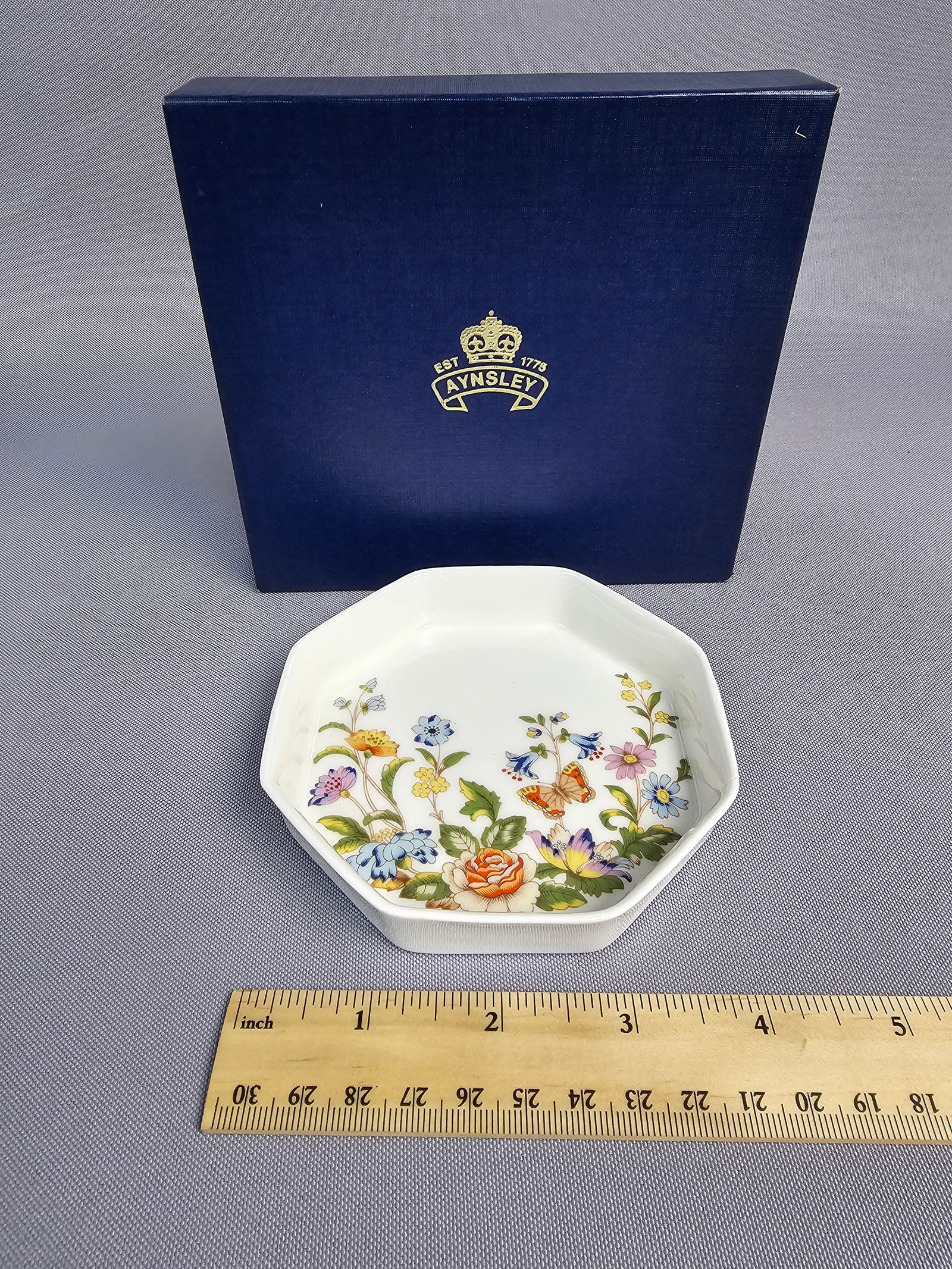 A Collection of Decorative Porcelain and Glass Tableware including Aynsley China Trinket Dish: This collection features a storage jar with a wooden lid and wildflower motifs. The earthenware jar has a ribbed cylindrical body and bears a backstamp for Winterling Marktleuthen, Bavaria. The lot in