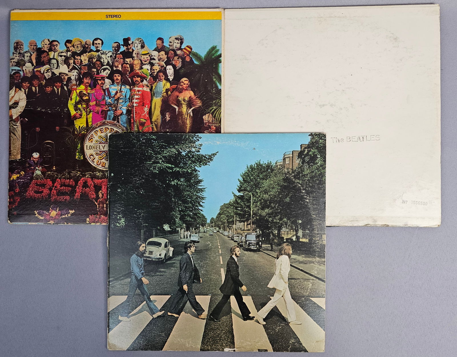 A Trio of The Beatles Vinyl LP Albums including Abbey Road and Sgt. Peppers Lonely Hearts Club Band: A trio of vinyl LP albums by The Beatles, including Abbey Road, Sgt. Peppers Lonely Hearts Club Band, and the self-titled double LP known as the White Album. The Abbey Road album, catalog number