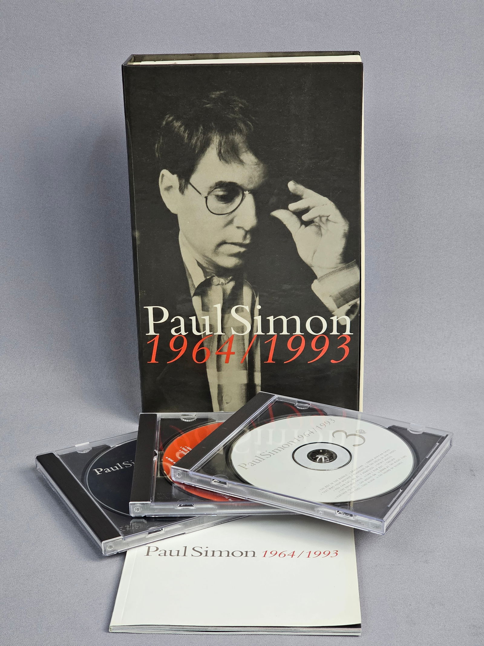 Paul Simon 1964/1993 3-CD Box Set: This Paul Simon 1964/1993 compilation box set was released in 1993 by Warner Bros. Records. The set includes three compact discs housed in plastic jewel cases and a multi-page companion booklet.