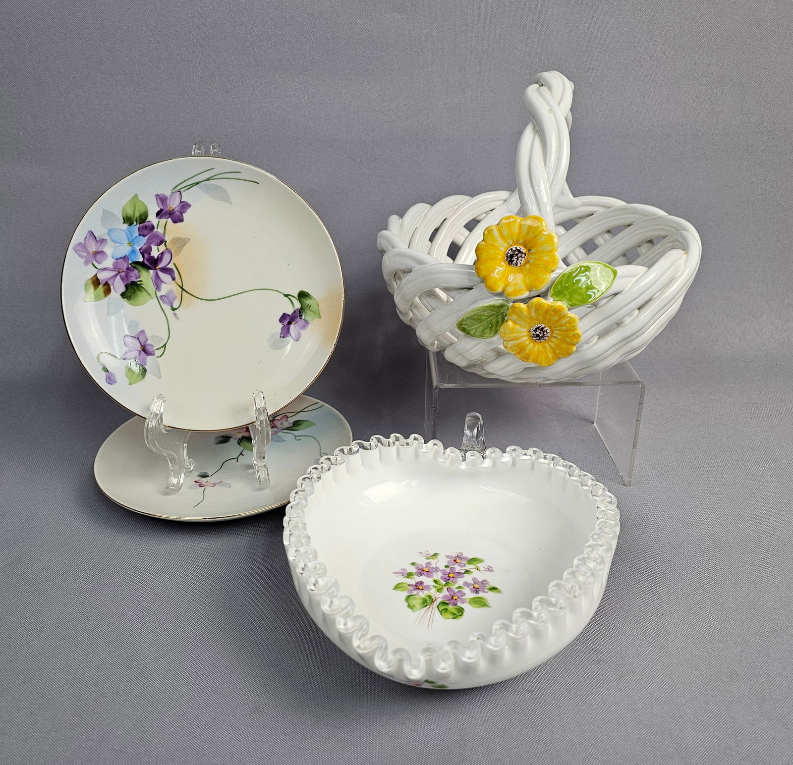 A Collection of Hand-Painted Porcelain and Glass Tableware Including Nippon: A collection of decorative tabletop items featuring hand-painted porcelain and glass. The group includes two porcelain plates, one of which bears a green crown backstamp marked Hand Painted Nippon and