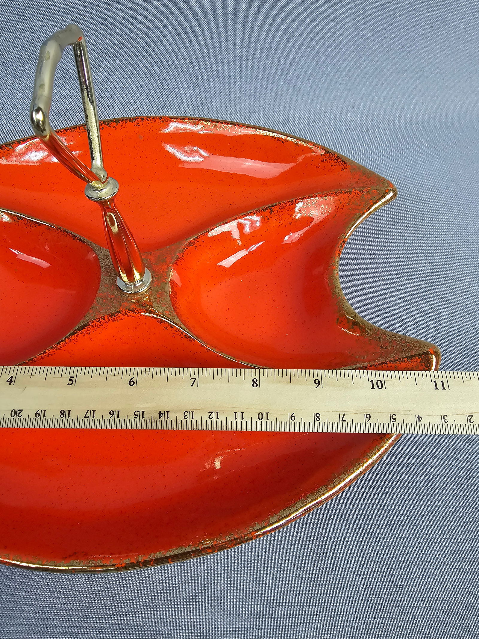 California Originals Mid-Century Modern Atomic Orange Divided Serving Tray: A California Originals mid-century modern ceramic serving tray. The piece features a three-compartment divided form with a boomerang-inspired silhouette. It is finished in a vibrant orange glaze accen