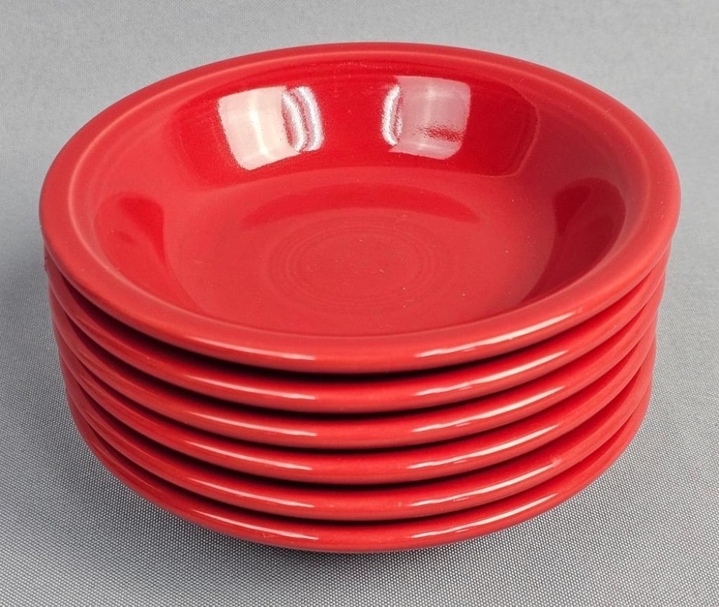 A Collection of 6 Fiesta Homer Laughlin Fruit Bowls: A collection of glazed ceramic fruit bowls in the Fiesta pattern by the Homer Laughlin China Co. The bowls are finished in the Scarlet glaze, a color introduced in 2004. Each piece features the signat