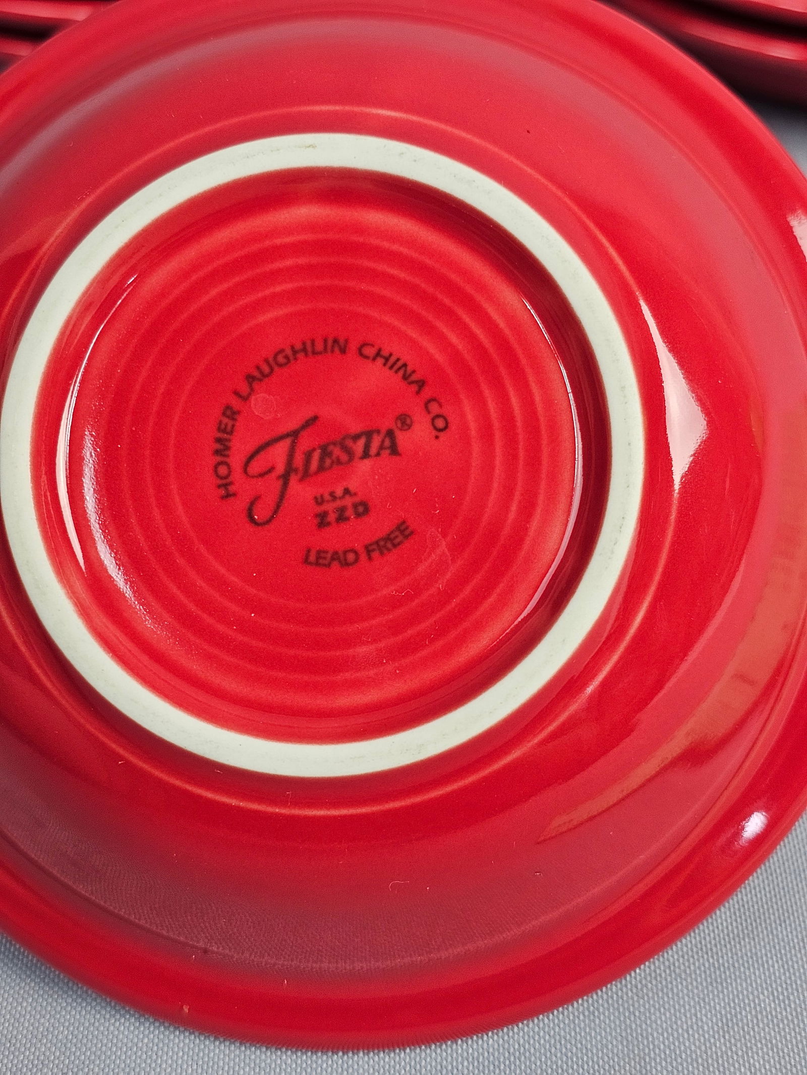 A Collection of 6 Fiesta Homer Laughlin Fruit Bowls: A collection of glazed ceramic fruit bowls in the Fiesta pattern by the Homer Laughlin China Co. The bowls are finished in the Scarlet glaze, a color introduced in 2004. Each piece features the signat