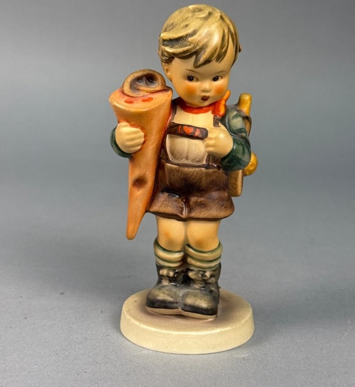 Goebel Hummel Little Scholar Figurine Number 80 TMK3: A Goebel Hummel hand-painted porcelain figurine titled Little Scholar, model number 80. T The figurine is set upon a circular cream-colored base. The underside is marked with a blue Goebel W. Germany