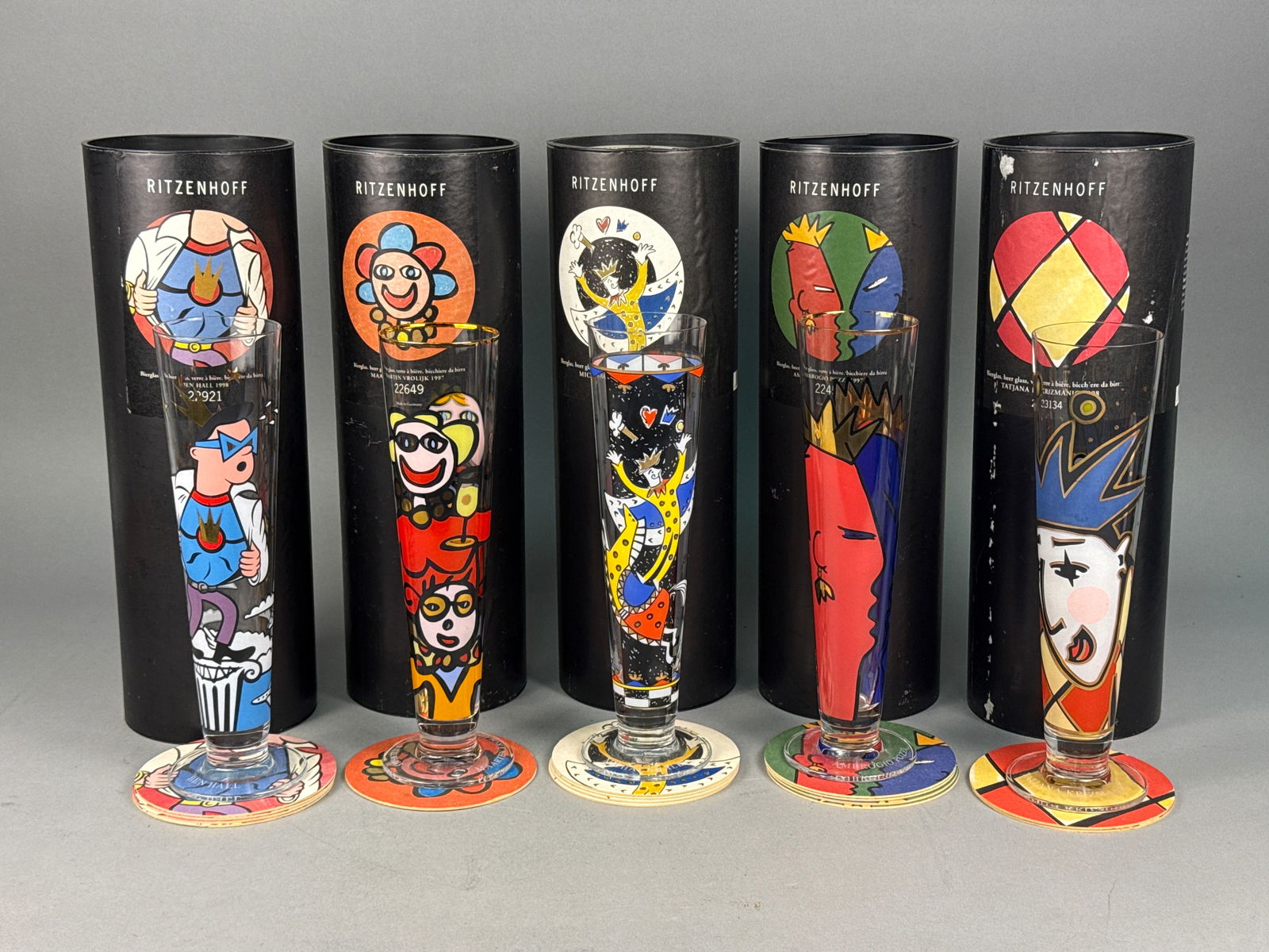 A Collection of Ritzenhoff Bierglas Pilsner Beer Glasses: A collection of Ritzenhoff Bierglas pilsner-style beer glasses, manufactured in Germany during the late 1990s. Each glass features multi-colored graphic illustrations by contemporary artists, includin