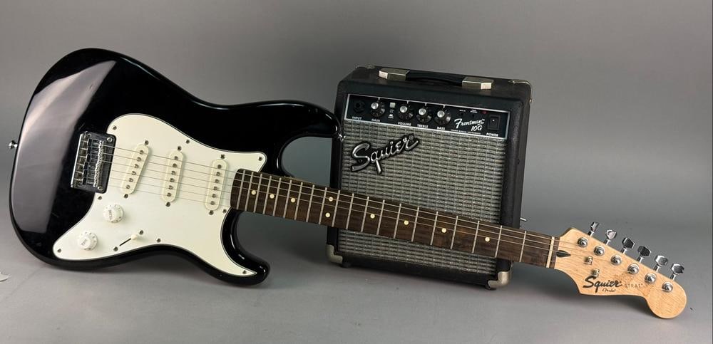 Squier Strat Pack SSS with Fender Frontman 10G Amplifier: A Squier Strat Pack SSS consisting of an electric guitar and a Fender Frontman 10G practice amplifier. The guitar features a double-cutaway body with a black gloss finish, a three-ply white pickguard,