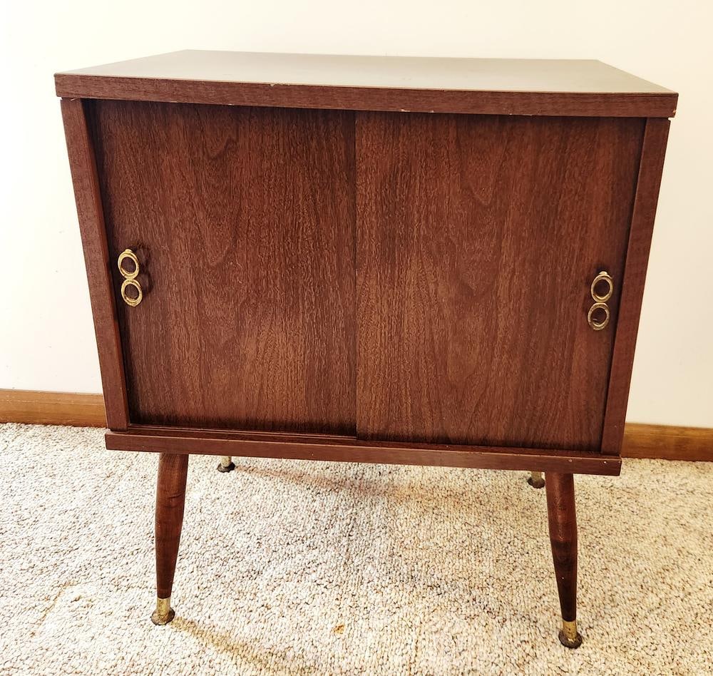Lu Van Inc. Mid-Century Modern Walnut Veneer Record Cabinet: A mid-century modern record cabinet manufactured by Lu Van Inc. of Belding, Michigan. The cabinet features a walnut wood veneer construction with a particleboard back panel. The front is designed with