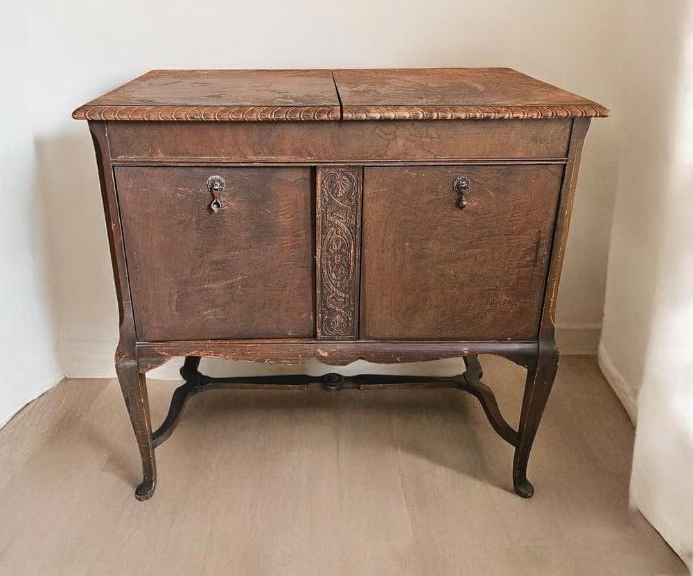 Fischer Console Phonograph, New York, Early 20th Century: Measures 34 x 35 x 21 inches. The cabinet shows significant wear to the finish, particularly on the top surfaces and legs. There are visible surface scratches, scuffs, and areas of finish loss