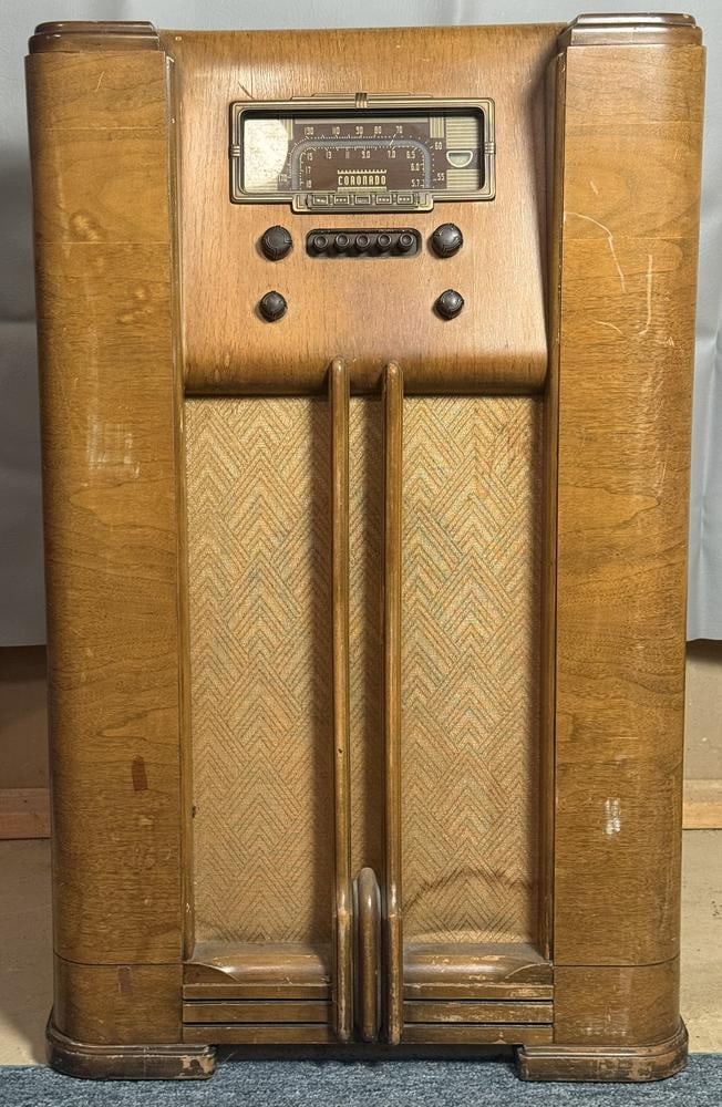 Coronado Model 407-V Art Deco Console Floor Radio: This item is located in the basement. A Coronado model 407-V console floor radio. The wood cabinet features decorative veneers and a stepped Art Deco profile with a chevron-patterned fabric speaker gr