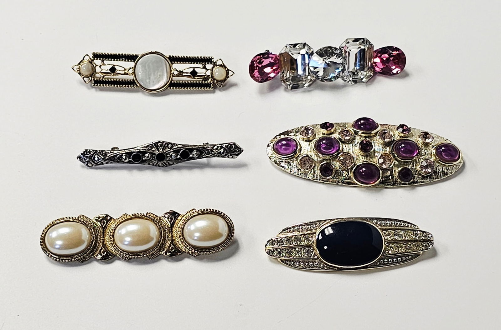 Vintage Art Deco and Modernist Style Brooch Collection Inc JONI: This collection consists of six vintage costume jewelry brooches. The assortment includes a gold-tone Art Deco style bar brooch with mother-of-pearl cabochons and black enamel; a silver-tone filigree