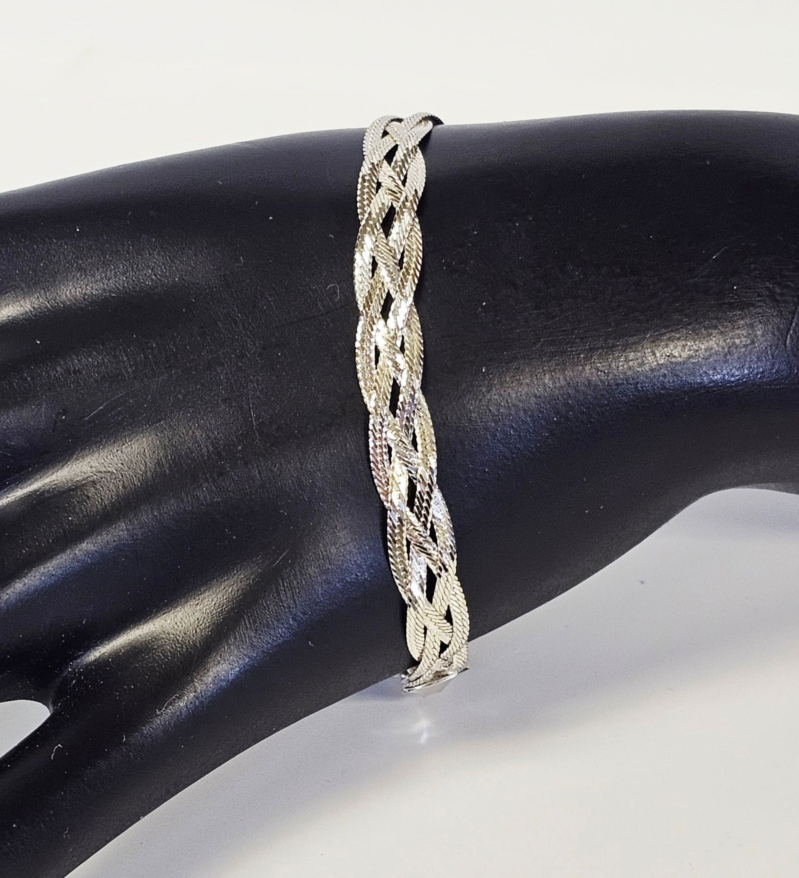 Sterling Braided Multi-Strand Bracelet 6.6 Grams: This sterling silver bracelet features a multi-strand woven design composed of braided flat links. The piece is secured with a lobster claw clasp. It is hallmarked 925MEX on the end cap, signifying it