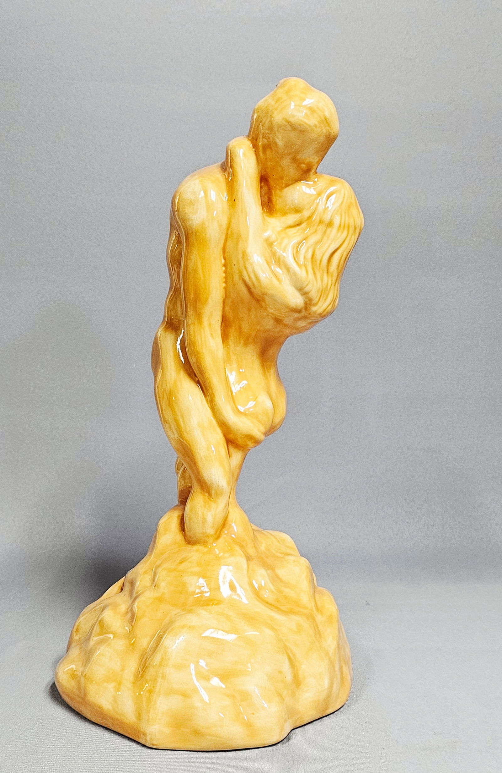 Vintage Glazed Ceramic Kissing Couple Sculpture: Denise Pettinger, glazed ceramic, an interpretation of Auguste Rodin's The Kiss depicting two nude figures in an intimate embrace, high-gloss amber-toned translucent glaze over a white ceramic body,