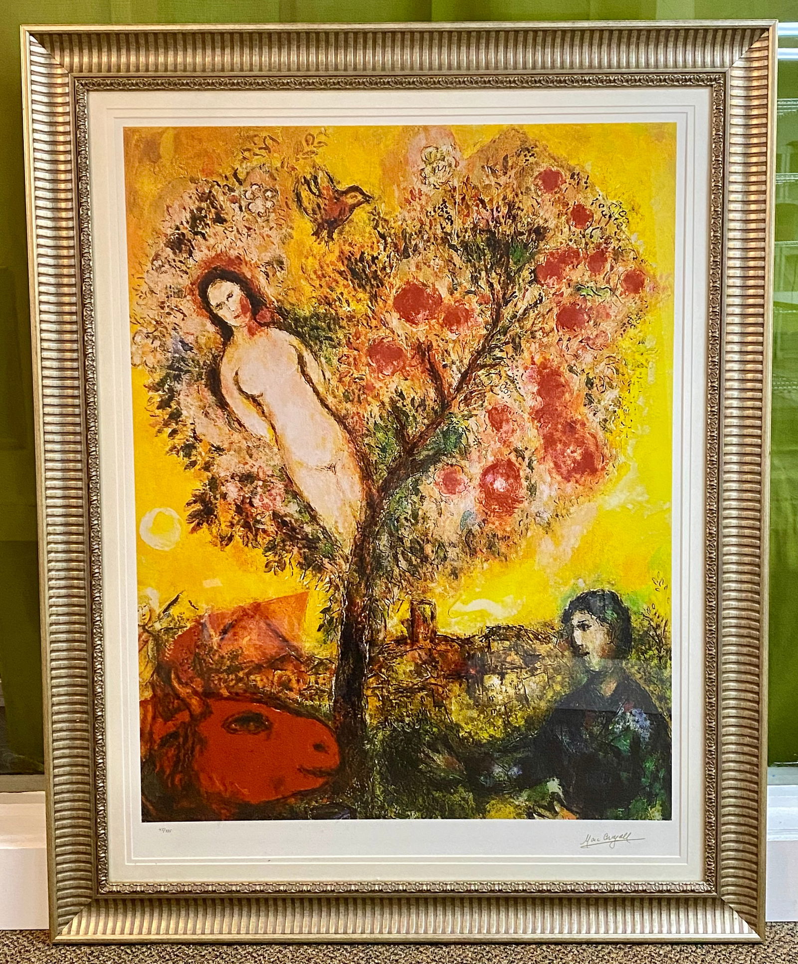 Marc Chagall Tree Over Village Limited Edition Facsimile Print: A limited edition facsimile print titled Tree Over Village after the artist Marc Chagall (1887-1985). The surrealist composition depicts a central blossoming tree containing a nude female figure, flan