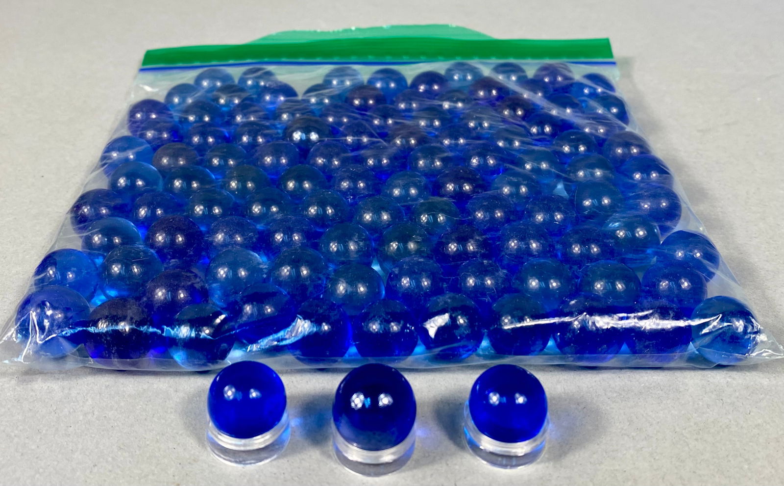 Galashield Bulk Cobalt Blue Glass Marbles, Late 20th/Early 21st Century: A large collection of machine-made translucent glass marbles, attributed to Galashield or similar mass-market manufacturers such as Futureplusx. These pieces are crafted from deep cobalt blue glass wi