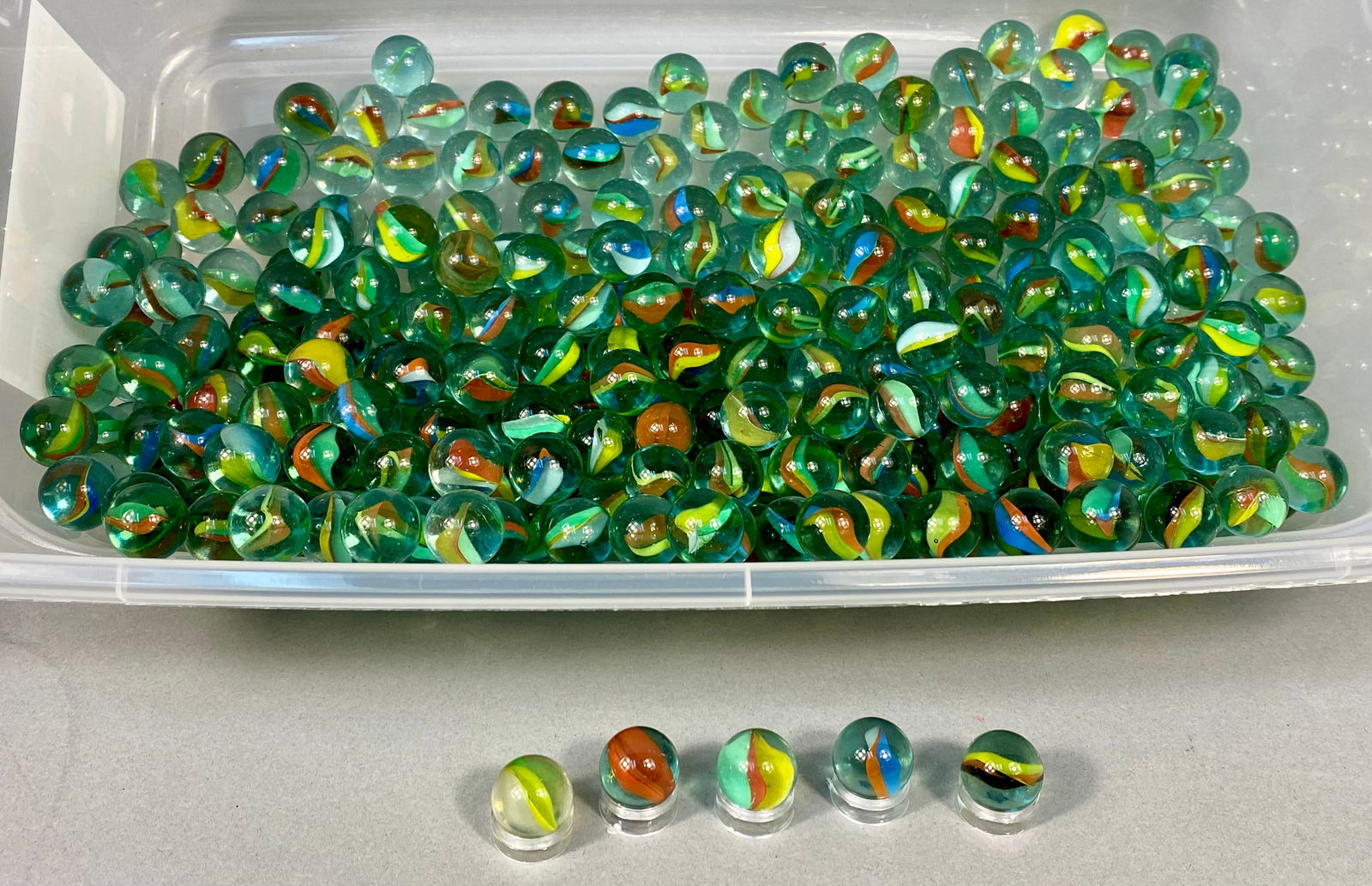 Vintage Assorted Glass Cat's Eye Marbles, Multi-Color Internal Vanes, Mid-20th Century: This collection features a large assortment of vintage machine-made glass marbles, primarily of the cat's eye variety. These marbles are characterized by their internal multi-colored vanes, which incl