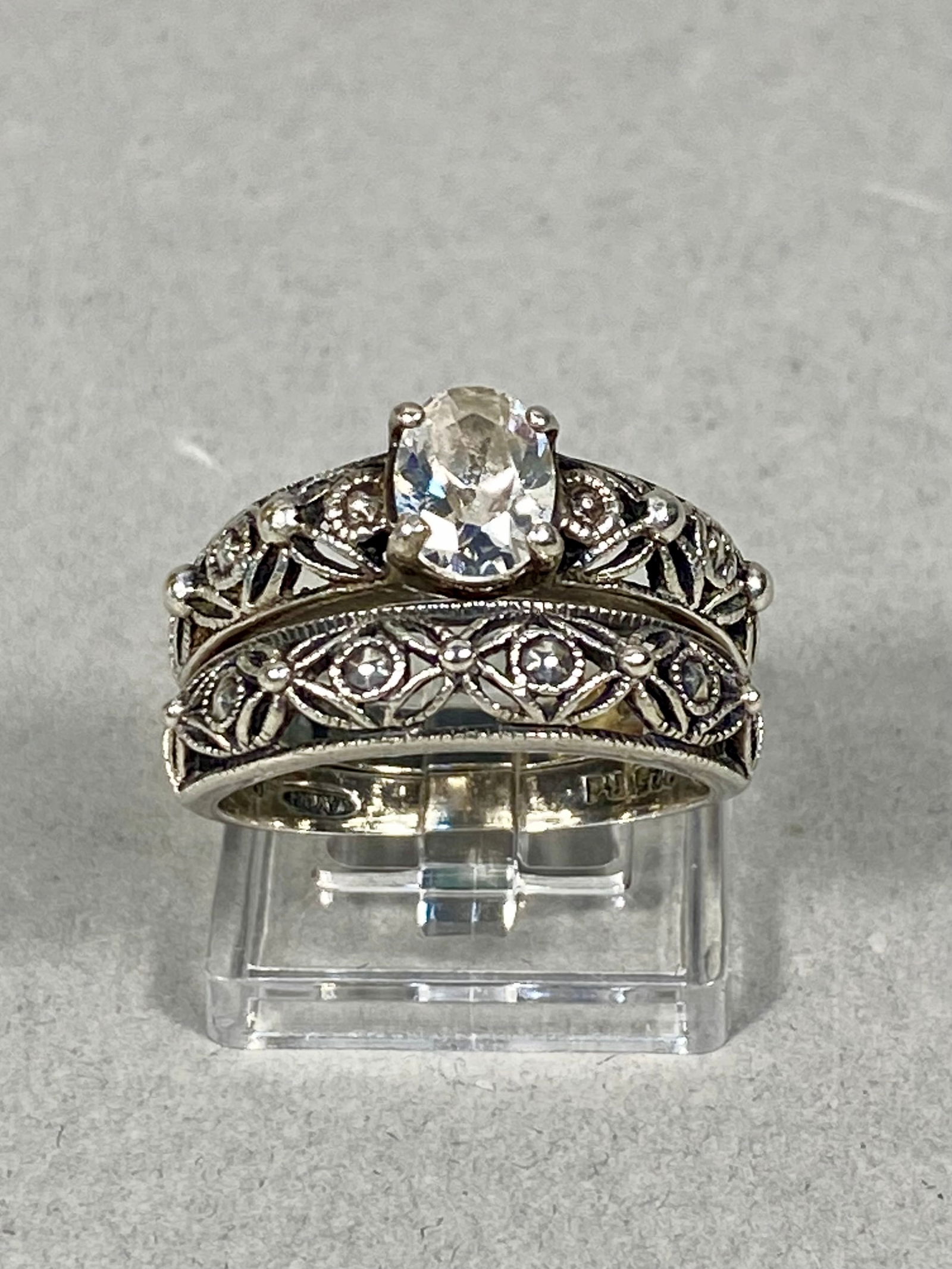 Sterling Silver Filigree Bridal Ring Set with Oval Clear Stone, Avon 5.33g: This matching two-piece bridal set is crafted in 925 sterling silver and features a vintage-inspired design. The engagement-style ring centers a four-prong set oval-cut clear stone, which appears to b