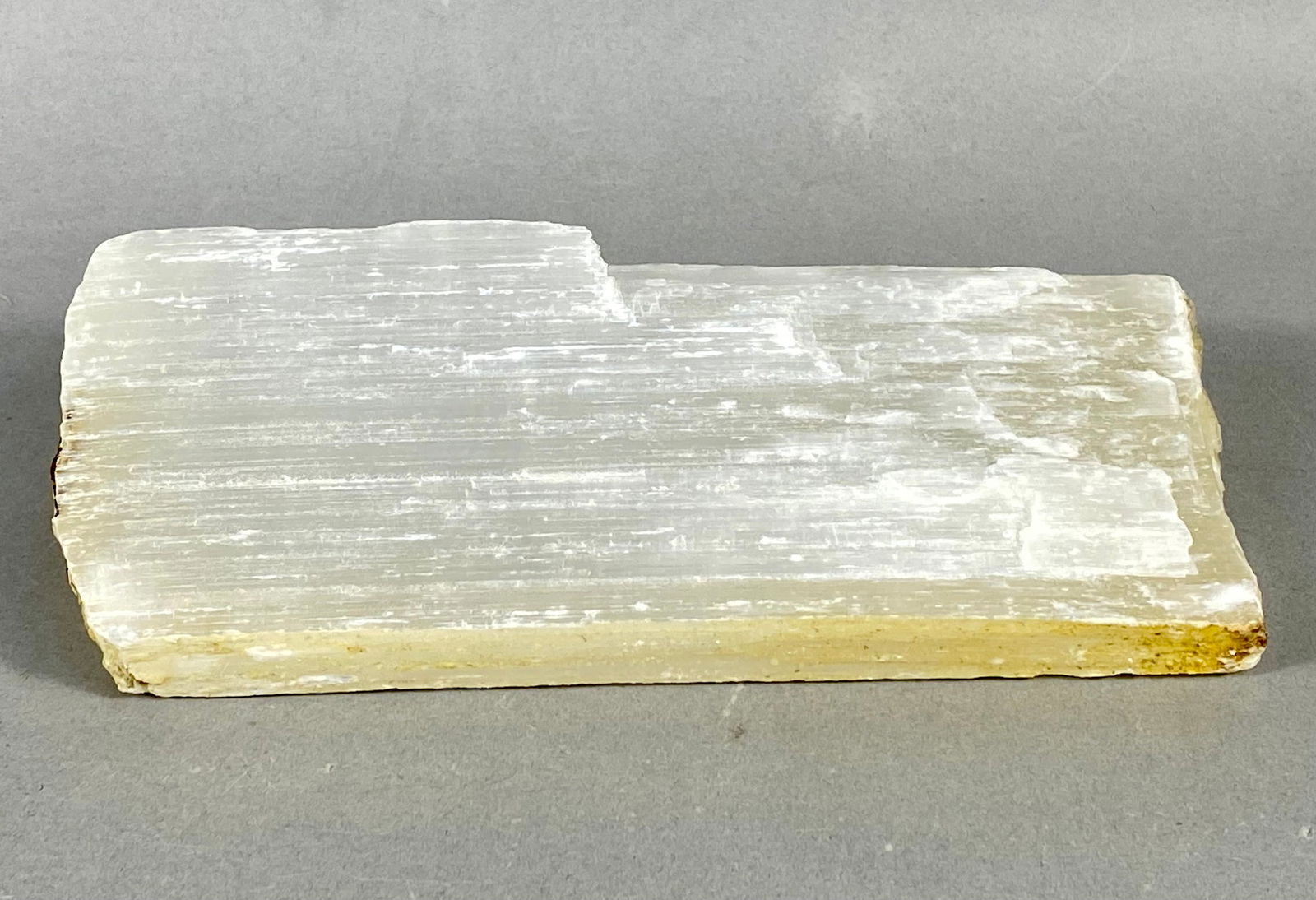 Natural Origin, Selenite Satin Spar Crystal Specimen, Contemporary: Natural origin, large rectangular selenite gypsum specimen. The material is a fibrous variety known as satin spar, exhibiting a brilliant pearly chatoyancy. The specimen is translucent white with