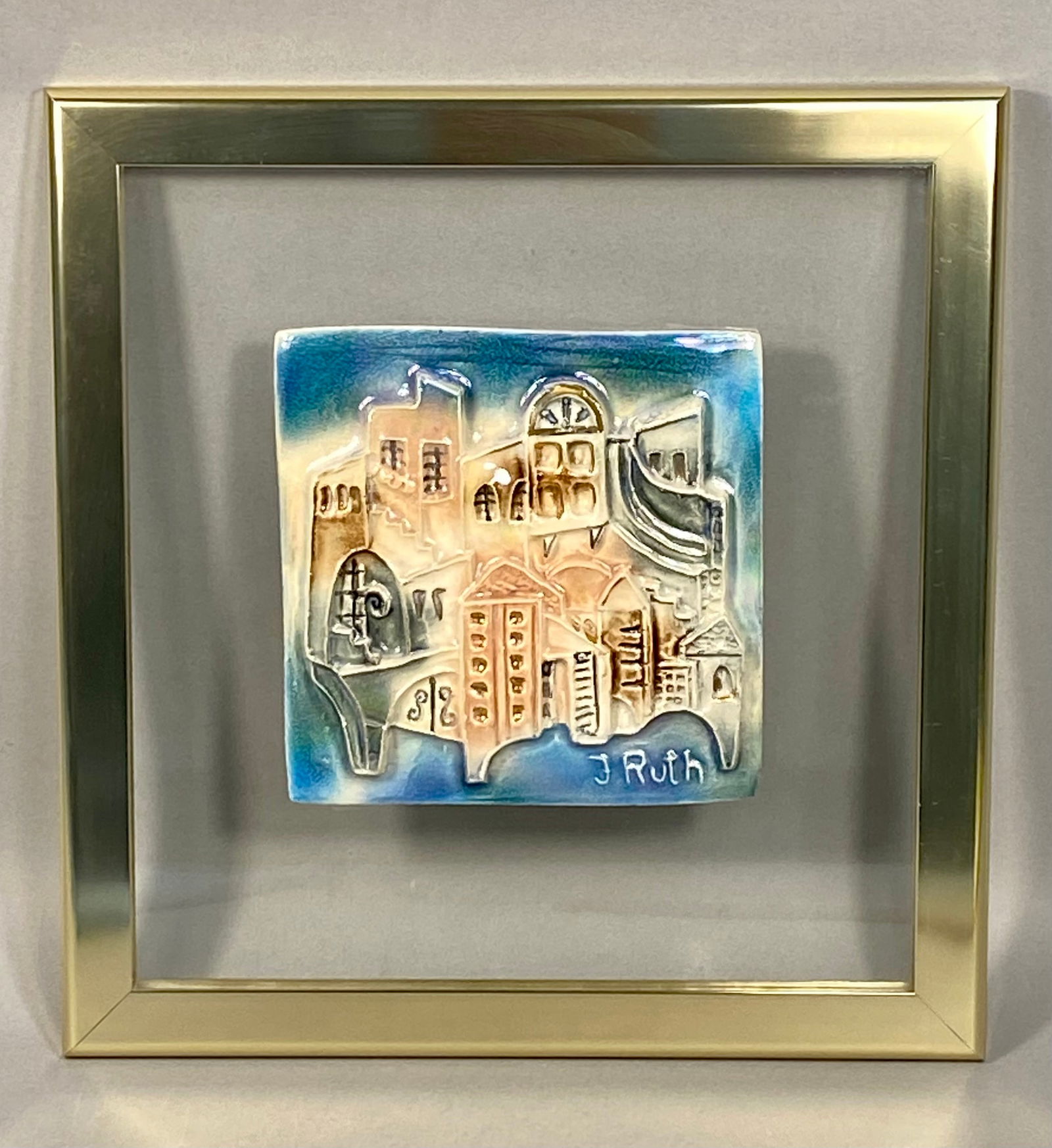 Jerusalem Cityscape, Signed Ruth Faktor Ceramic Relief Tile, Circa Late 20th Century: A handmade glazed ceramic relief plaque depicting a whimsical, stylized architectural composition of Jerusalem. The work features high-relief buildings with varied window designs, arches, and structur