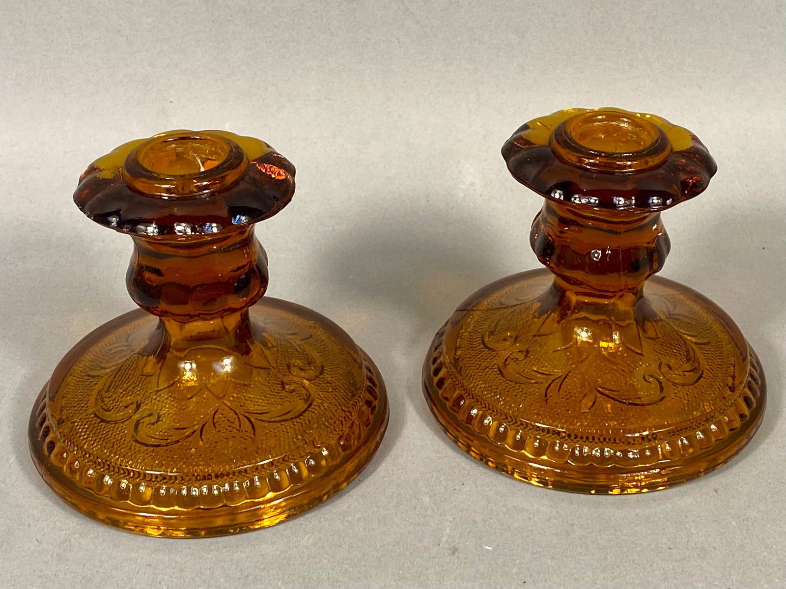 Pair of Amber Pressed Glass Candlesticks in the Sandwich Pattern (1 of 3)