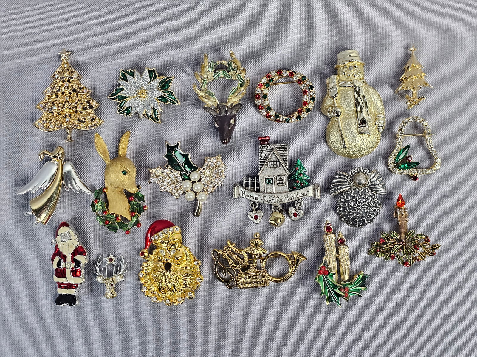 Mixed Metal Holiday Brooch Collection Including JJ and AJC: This collection features vintage Christmas-themed brooches in gold-tone and silver-tone base metals. The collection is in good vintage condition. Rhinestones and faux pearls appear secure and present