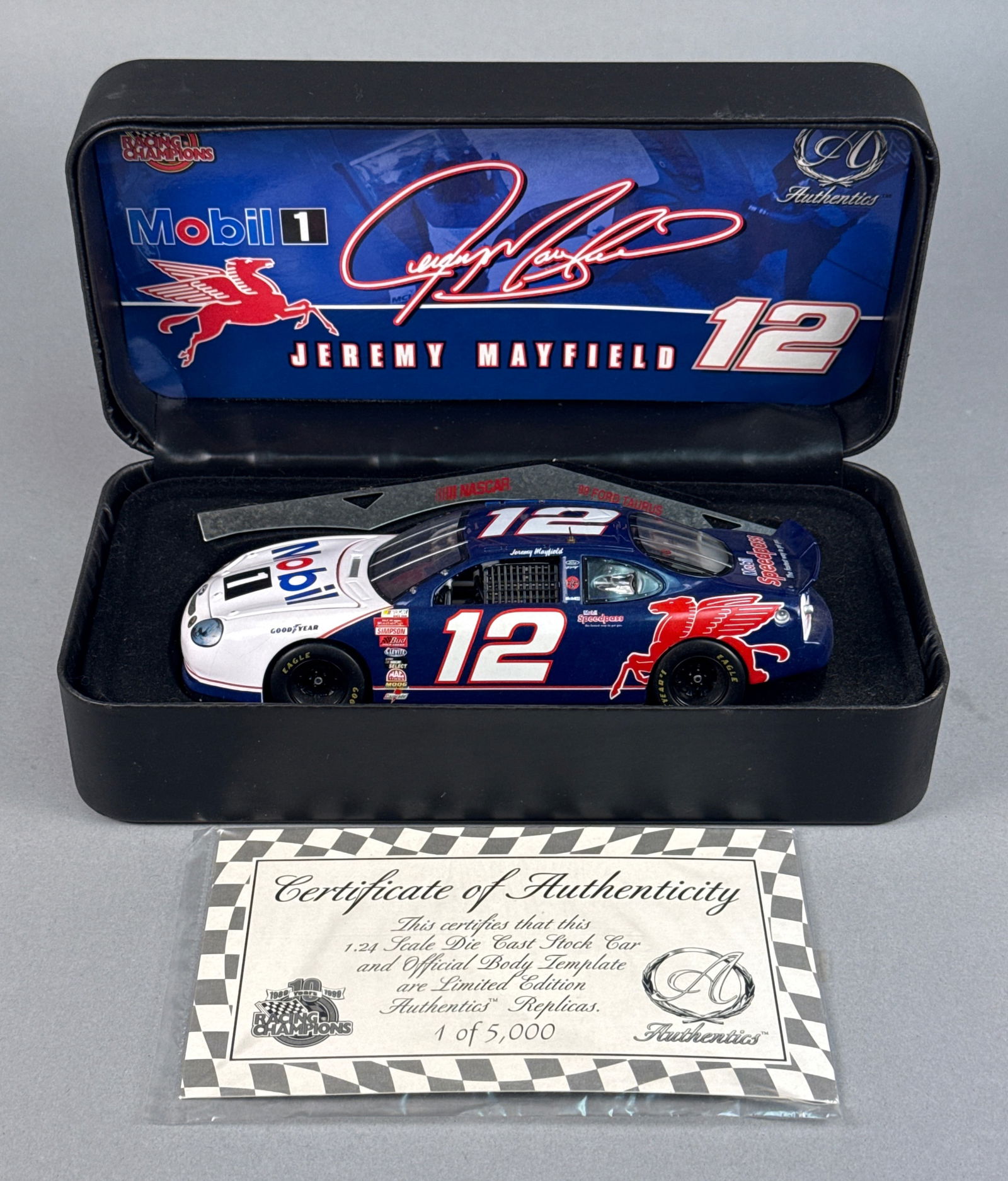 Racing Champions Authentics Jeremy Mayfield #12 Mobil 1 Ford Taurus Die-Cast Model, c. 1998: This lot features a Racing Champions Authentics 1:24 scale die-cast replica of Jeremy Mayfield's #12 Mobil 1 Ford Taurus, representing the 1999 NASCAR season. The vehicle is constructed of die-cast