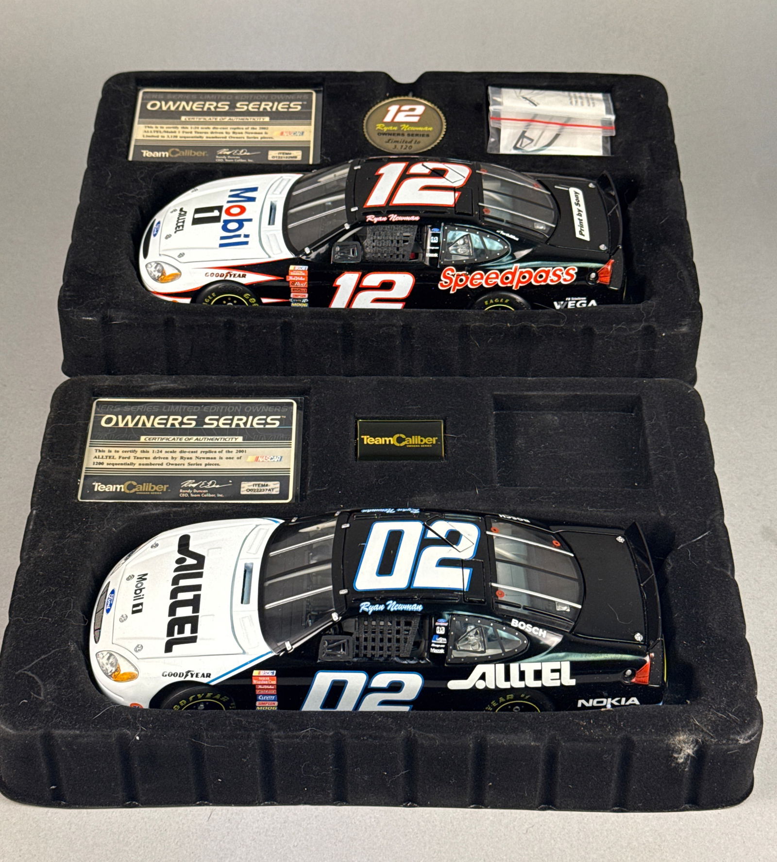 Team Caliber A Pair of Ryan Newman NASCAR Die-Cast Model Cars, 2001-2002 Limited Edition Owners: This lot features two professional-grade 1:24 scale die-cast replicas from the Team Caliber Owners Series, representing the early career of NASCAR driver Ryan Newman with Penske Racing. The first vehi