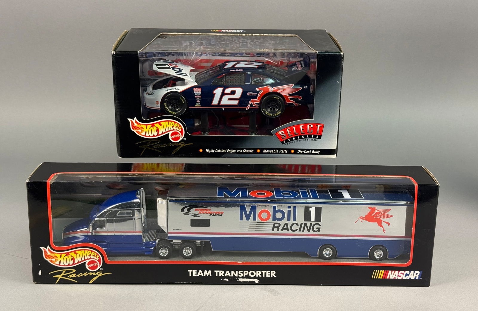 A Pair of Hot Wheels Racing Jeremy Mayfield #12 Mobil 1 NASCAR Die-Cast Vehicles: A pair of Hot Wheels Racing NASCAR die-cast collectibles featuring the #12 Mobil 1 Ford Taurus driven by Jeremy Mayfield. This lot includes a 1:24 scale Hot Wheels Racing Select model car and a matchi
