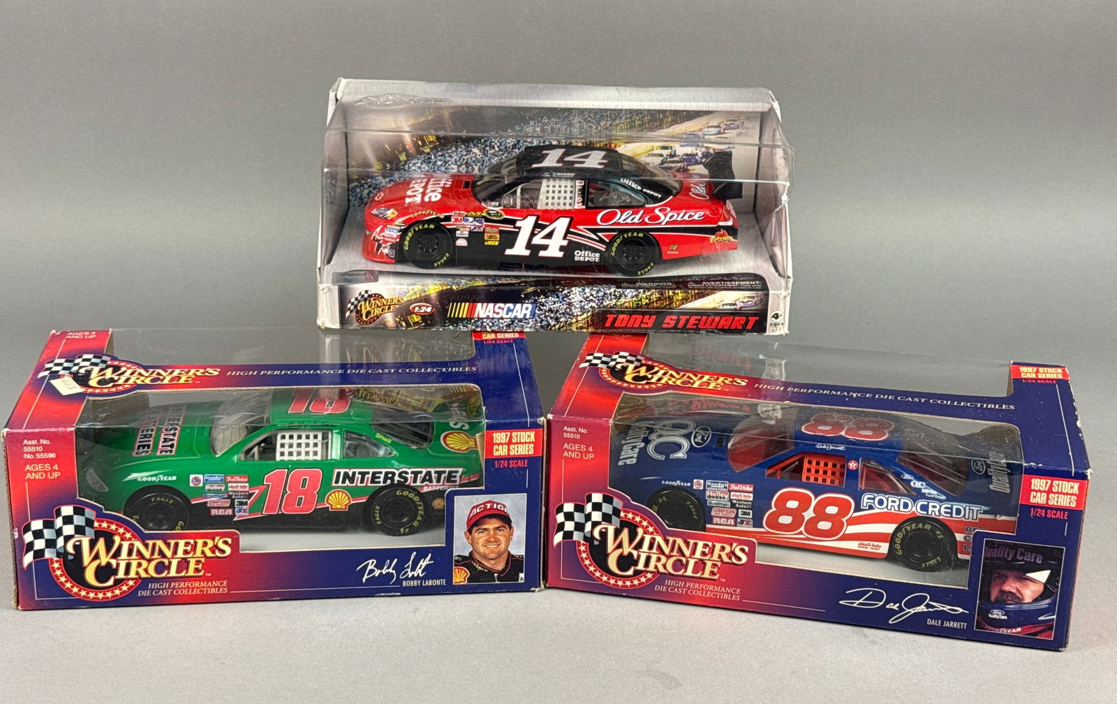 Winner's Circle NASCAR 1/24 Scale Die-Cast Model Cars, Three Pieces, 1997-2009: A collection of three 1/24 scale NASCAR die-cast model cars manufactured by Winner's Circle. The group features a 2009-2010 era Chevrolet Impala SS #14 driven by Tony Stewart for Stewart-Haas Racing,