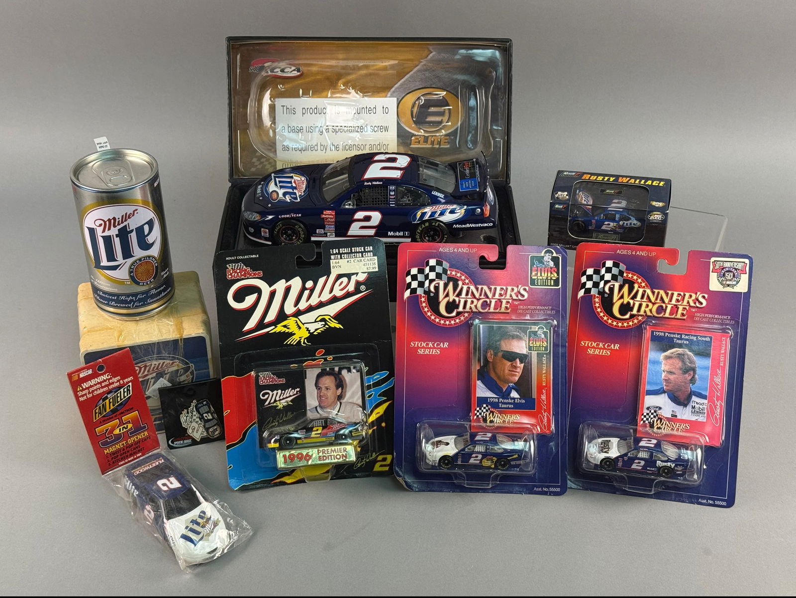 A Collection of Rusty Wallace NASCAR Die-Cast Models and Memorabilia: This collection features various NASCAR die-cast stock cars and promotional items centered on driver Rusty Wallace and the number 2 Miller Lite-sponsored car. The assortment includes several 1:64 scal